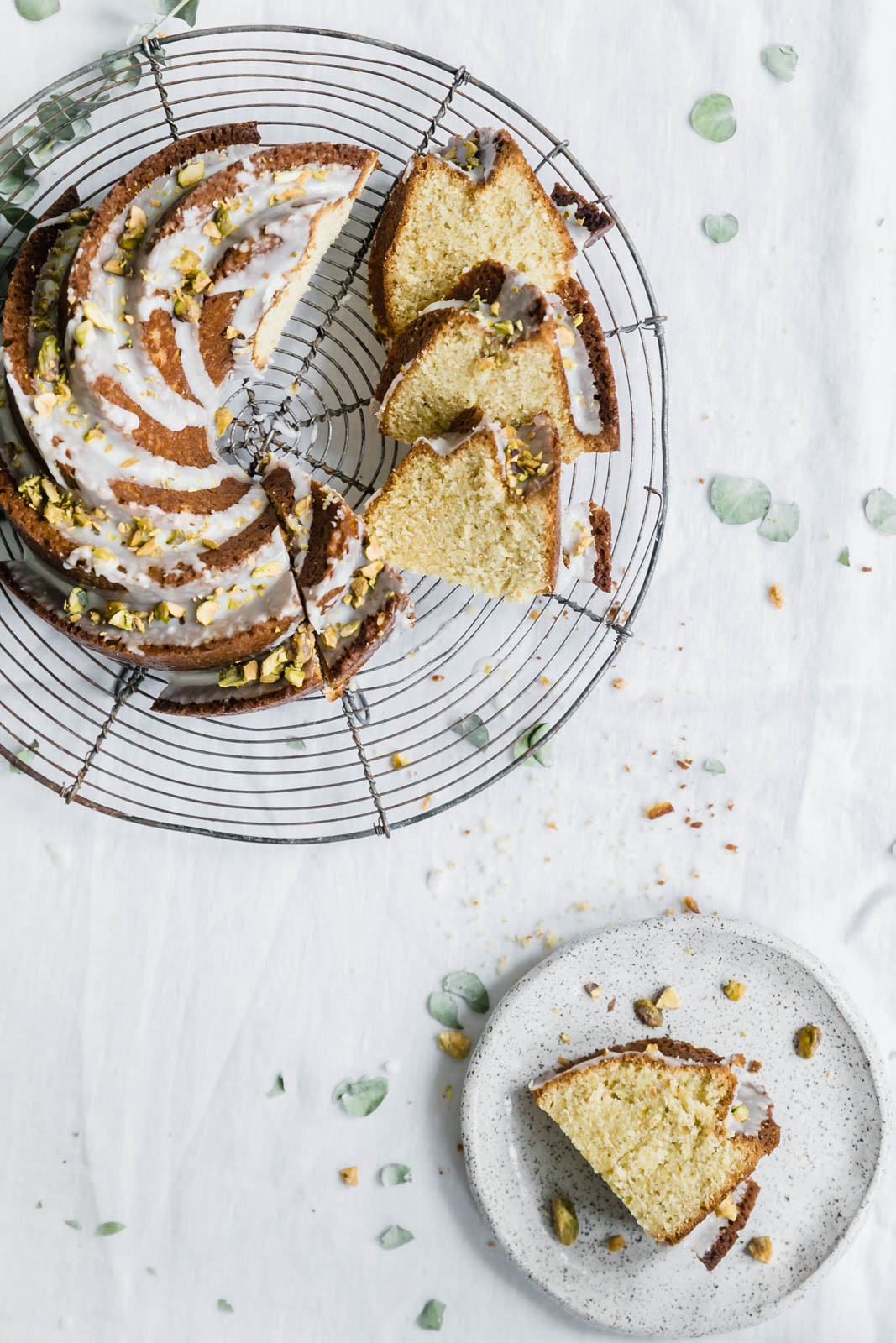 sliced pistachio olive oil cake on a wire rack
