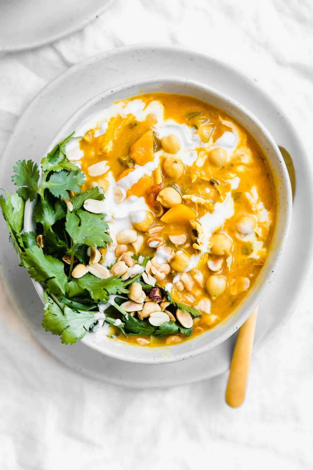 Turmeric Chicken Soup with peanuts and cilantro on top