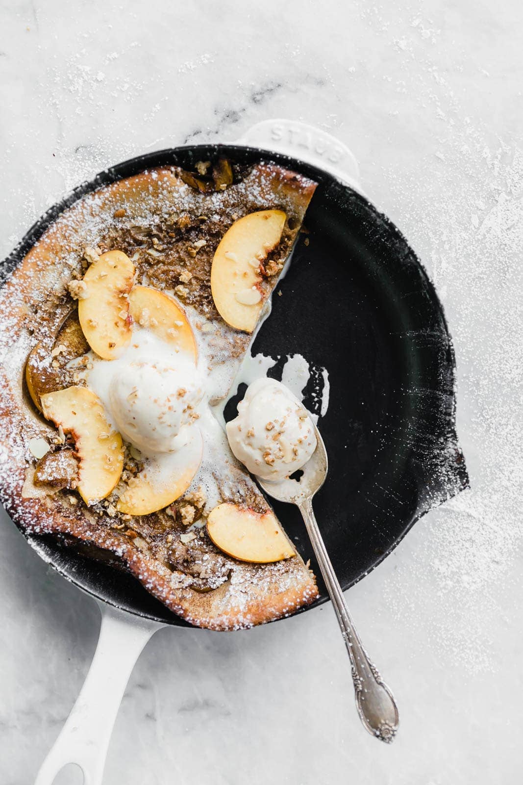 A deliciously epic bourbon brown butter peach dutch baby topped with granola, fresh peaches, and vanilla ice cream! Perfect for a lazy Sunday morning :)