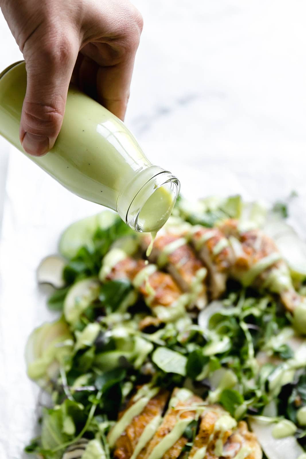 A loaded green chicken salad with watercress, green apples, farro, and a "creamy" dairy-free avocado dressing! So perfect for summer entertaining.