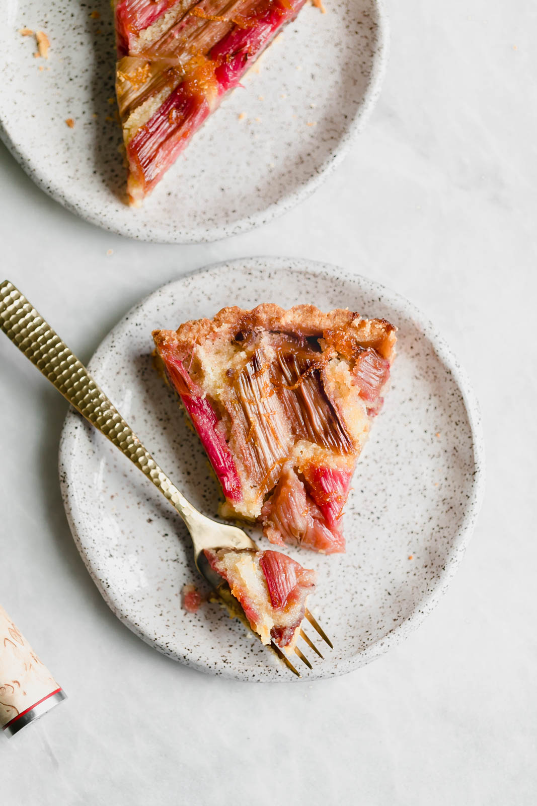 The most showstopping Rhubarb Bakewell Tart made with a pâte sucrée crust, strawberry preserves, almond frangipane, and an orange-soaked rhubarb top