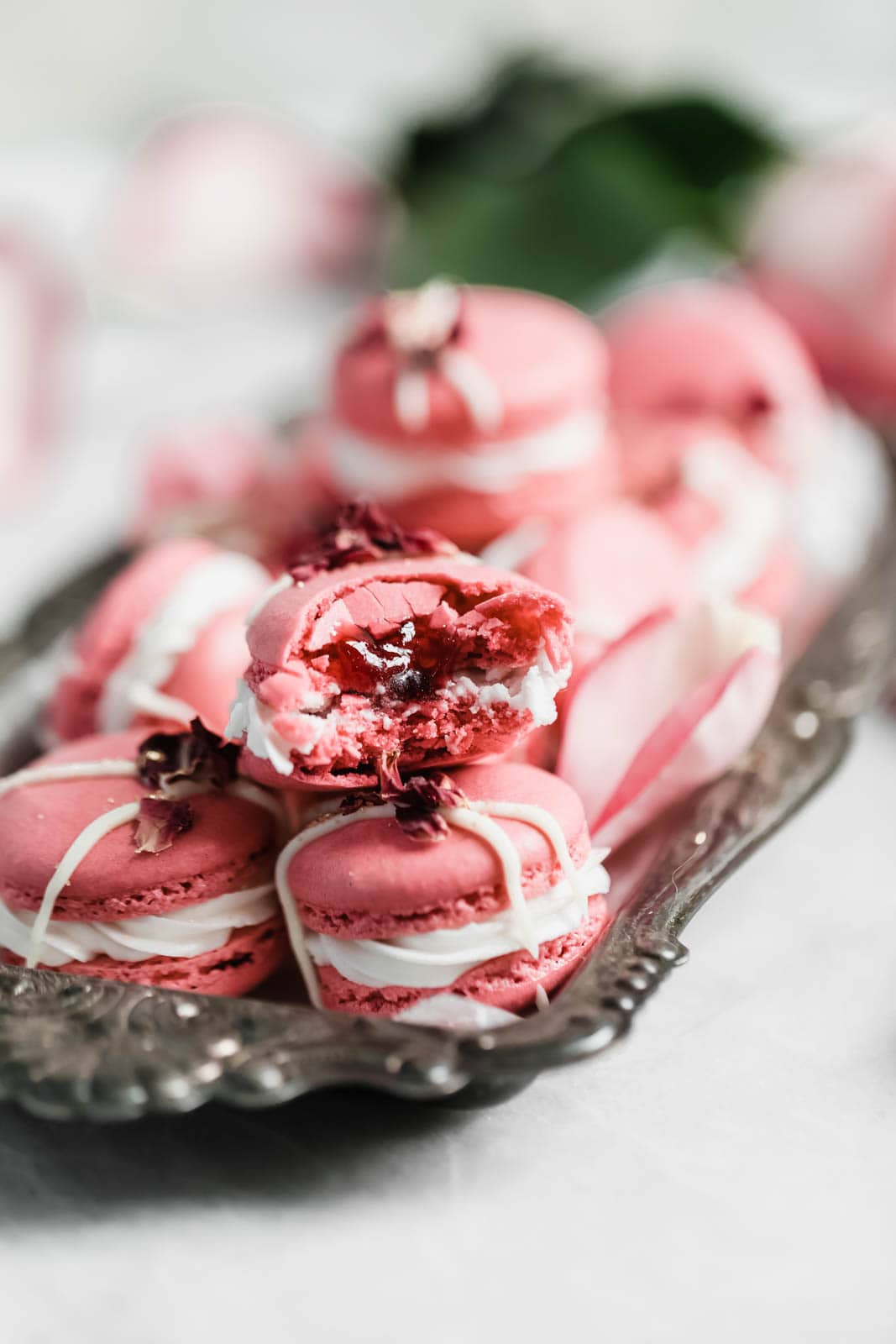 Raspberry Rose Macarons made with rosewater, a vanilla buttercream, and a surprise raspberry preserve center. Simple, elegant, and oh so delicious!! 