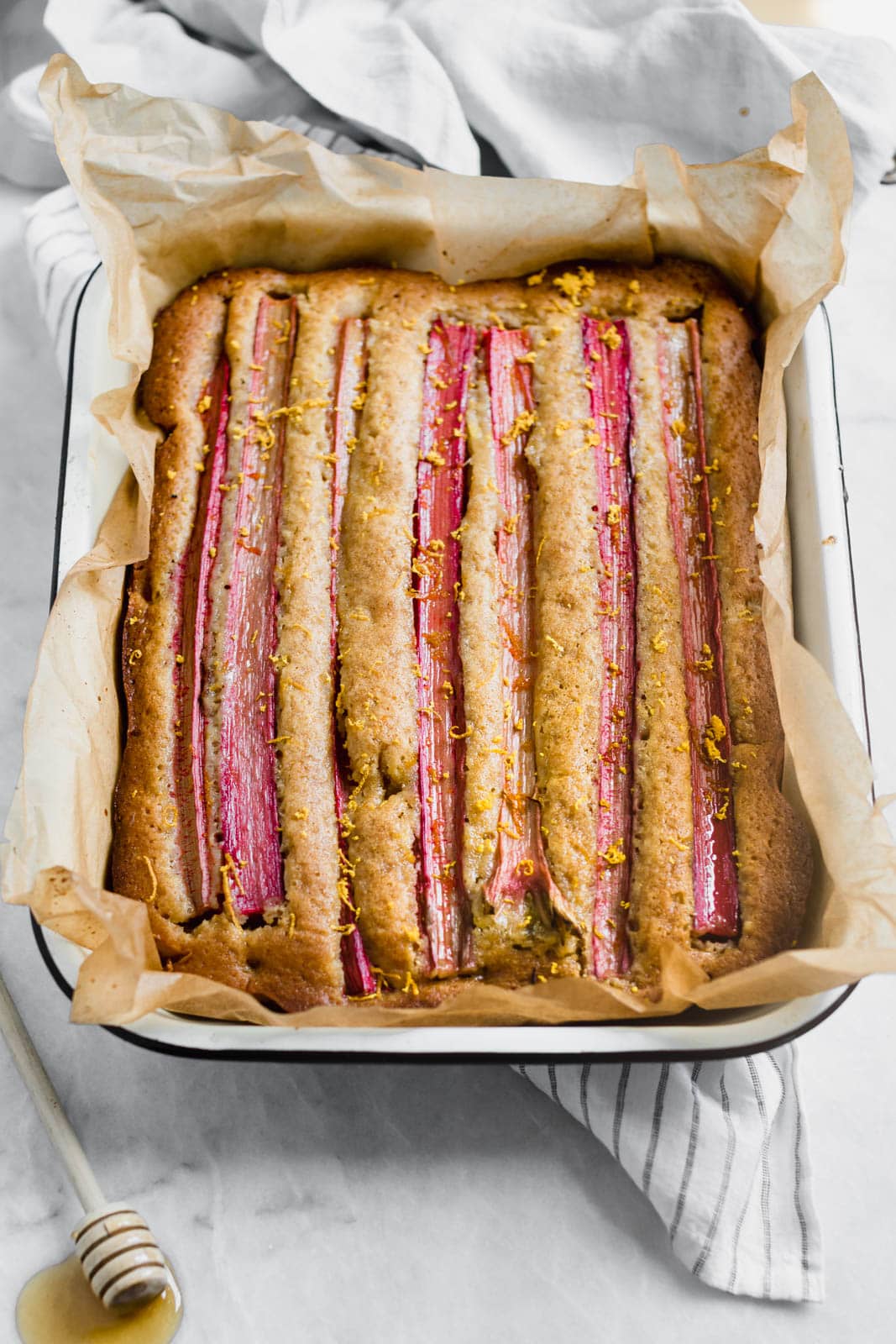 A rustic rhubarb almond honey cake with a hint of orange zest and wildflower honey. A perfect one-bowl snack cake ready in just 45 minutes!
