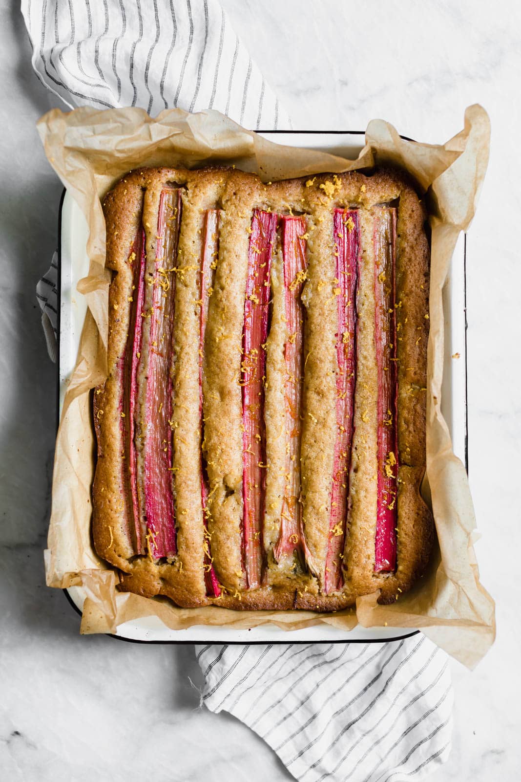 A rustic rhubarb almond honey cake with a hint of orange zest and wildflower honey. A perfect one-bowl snack cake ready in just 45 minutes!