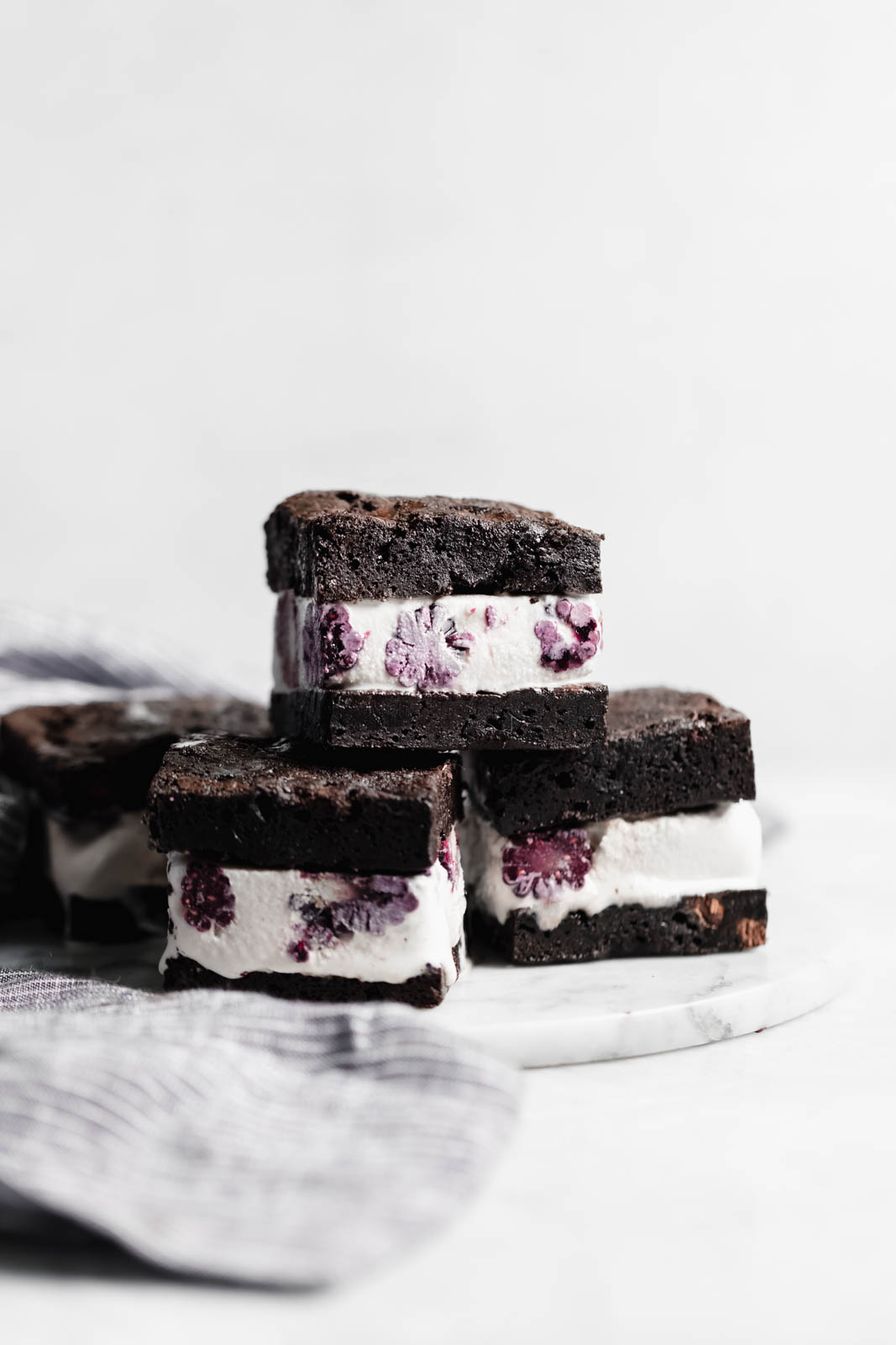 Brownie Ice Cream Sandwiches are the new thing. Made with boxed brownies and store-bought vanilla ice cream mixed with blackberry purée!