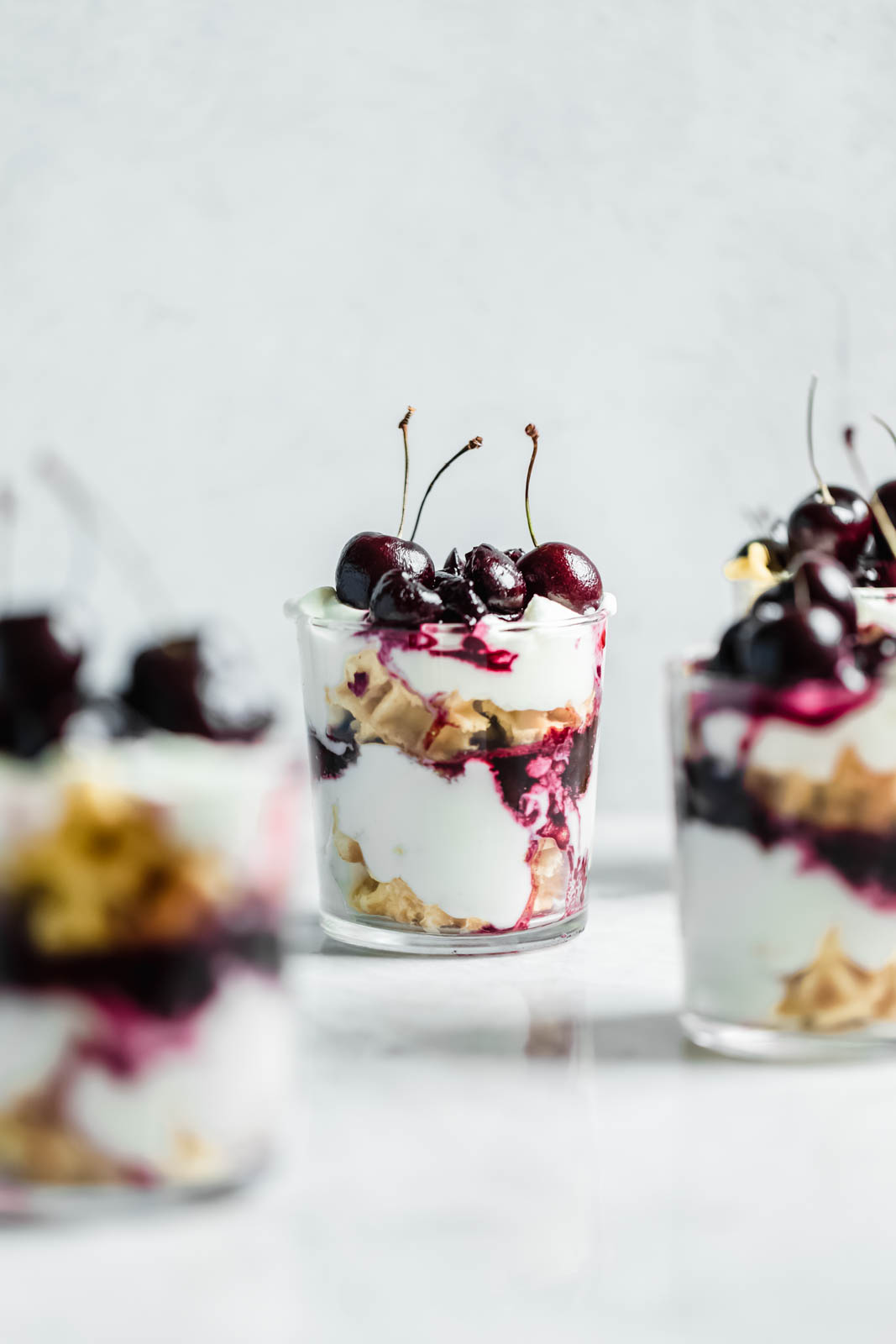 Layers of quick sautéed black cherries, fresh whipped cream, and Belgian waffles make this no-bake waffle parfait a total no-brainer summer dessert.