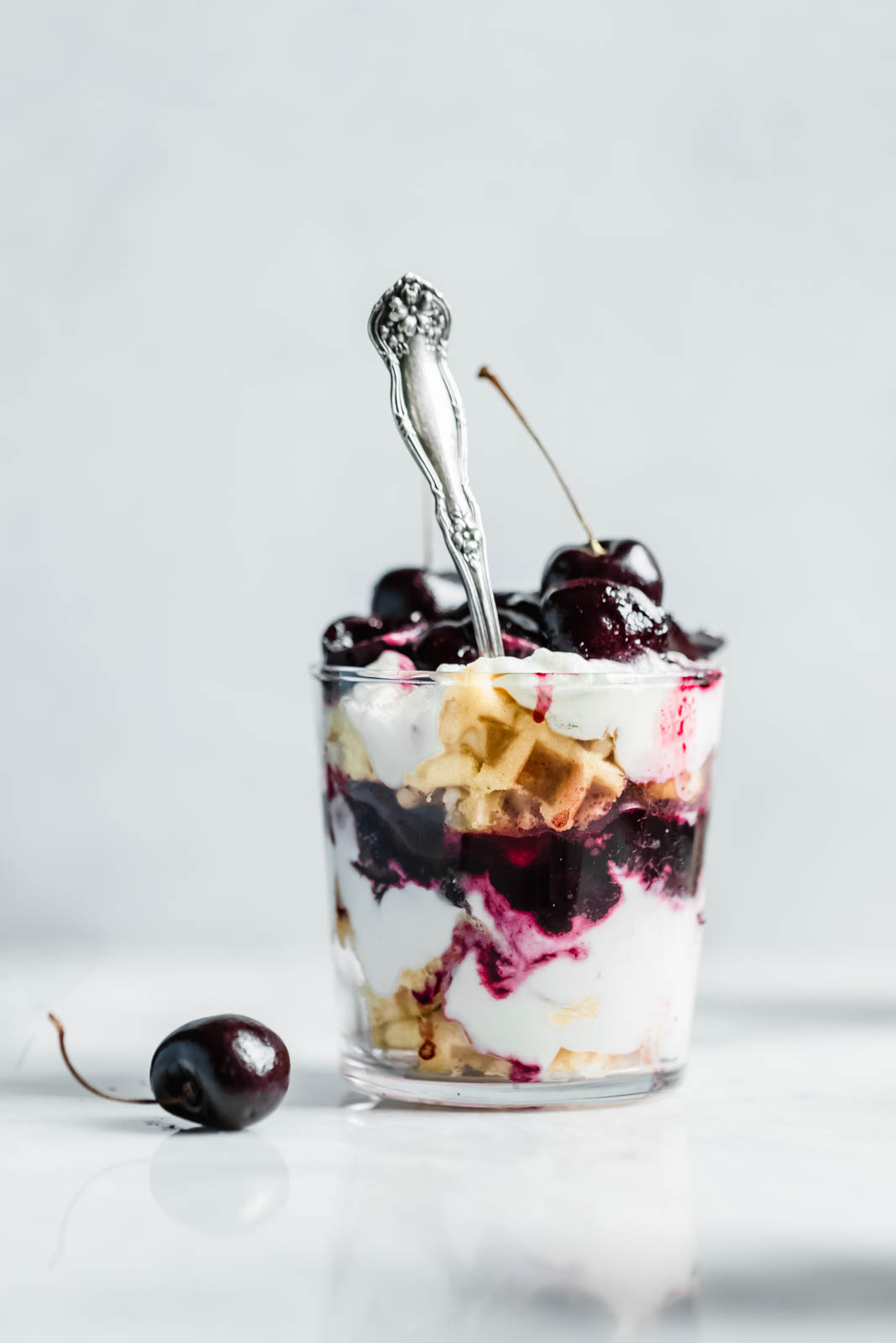 Layers of quick sautéed black cherries, fresh whipped cream, and Belgian waffles make this no-bake waffle parfait a total no-brainer summer dessert.