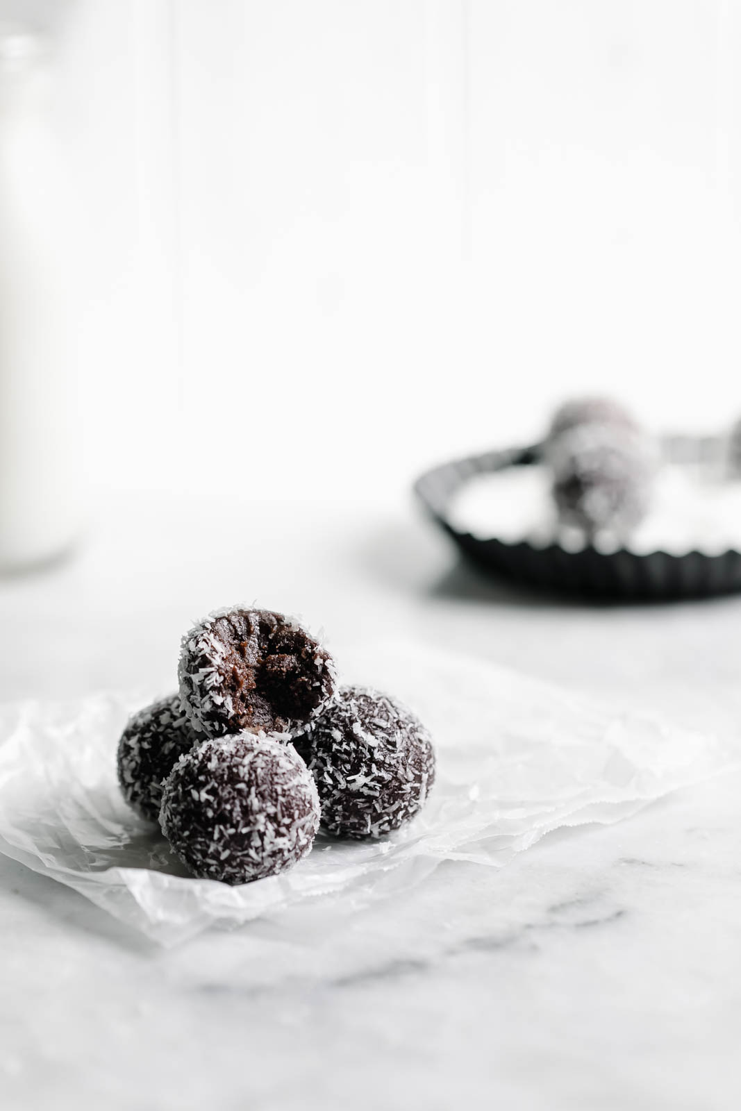 pile of chocolate date balls on paper wrapper