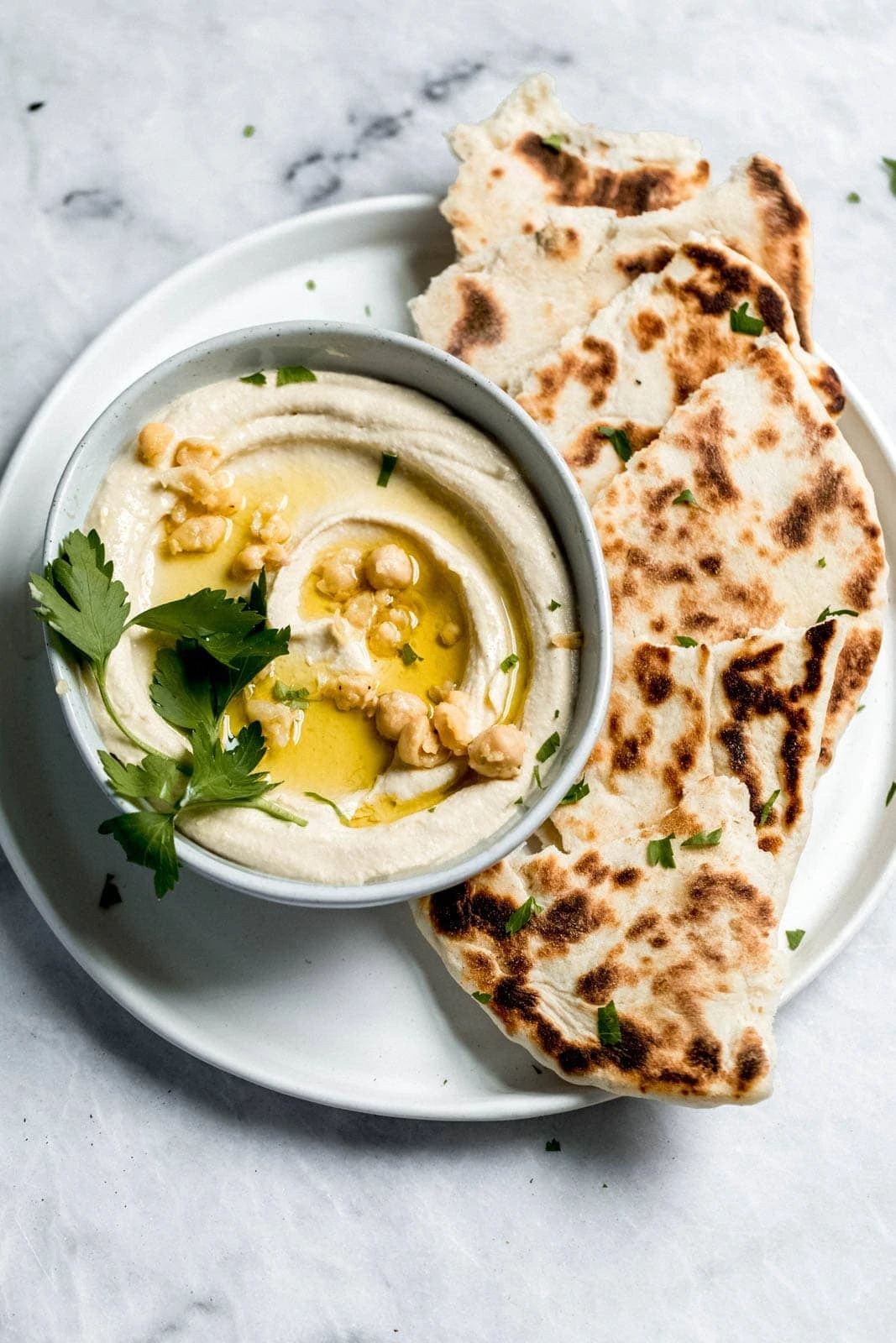 hummus on a plate with pita bread