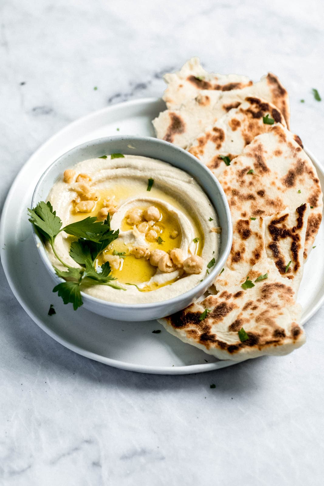 homemade hummus in a bowl with pita bread