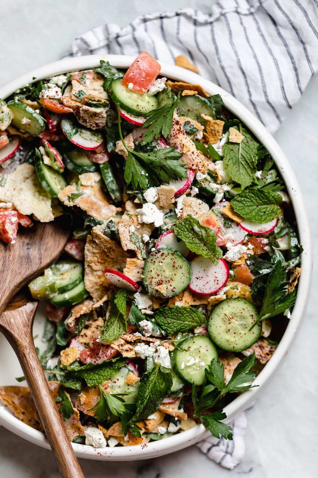 fattoush salad with wooden serving spoons