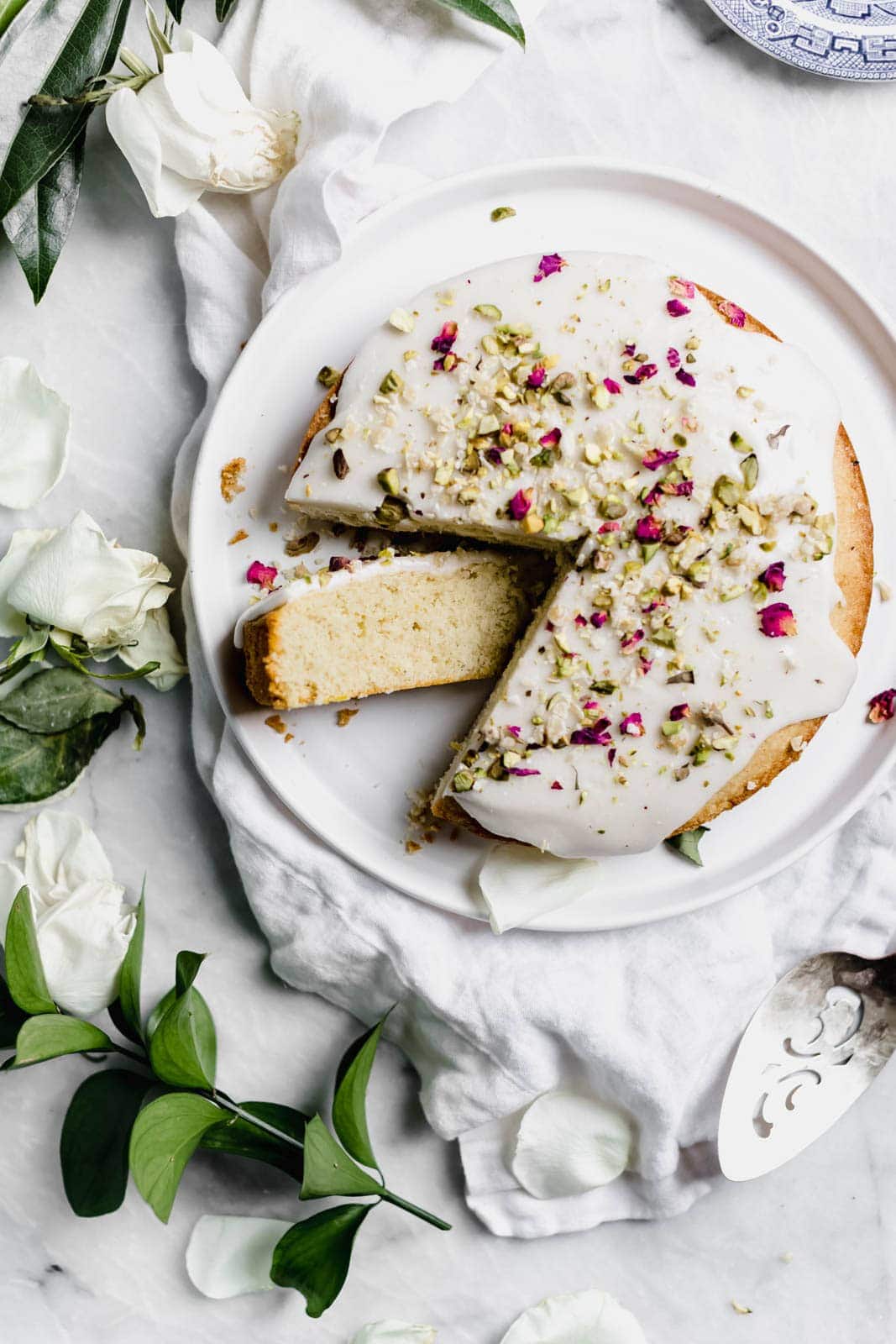 Persian Love Cake: a fragrant cake flavored with freshly ground cardamom, rose water, and almond flour, and topped with crushed pistachios and rose petals.