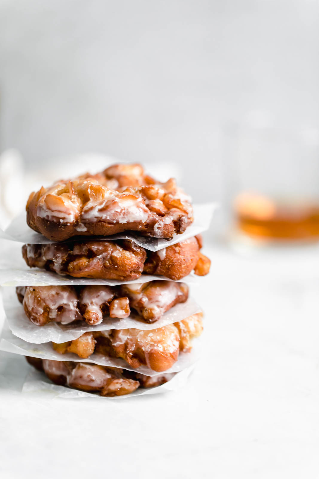 stacked bourbon apple fritters on countertop 