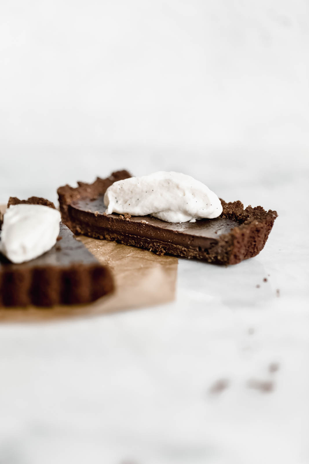A Mocha Chocolate Tart made with a chocolate graham cracker crust, rich mocha filling, and topped with a crème fraîche whipped cream!