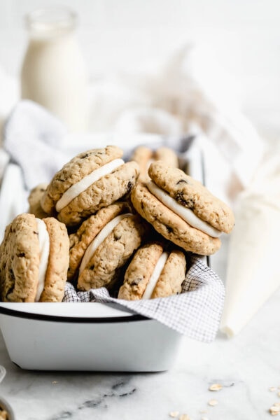 Easy to whip up on a weeknight, these chewy oatmeal whoopie pies are made with homemade oatmeal raisin cookies and a luxurious cream cheese frosting.