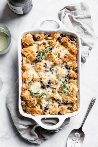 Savory Rosemary Olive Bread Pudding made with a rustic country loaf and loaded with cheesy goodness. A perfect alternative to stuffing at thanksgiving! 