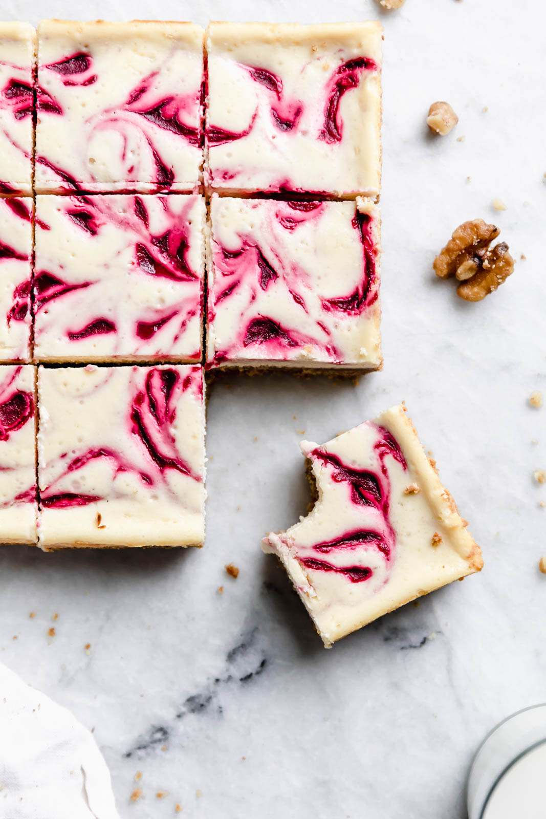 sliced Walnut Cranberry Cheesecake Bars on countertop