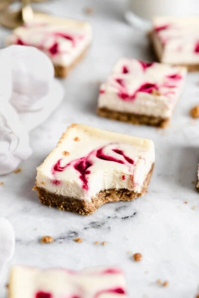 Totally creamy, slightly nutty, and utterly delicious, these Cranberry Walnut Cheesecake Bars make for a crowd pleasing winter dessert!
