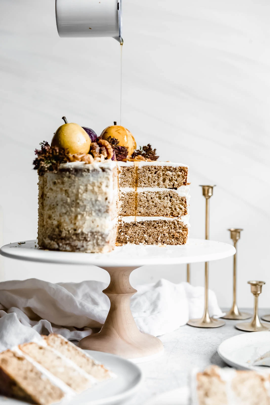 drizzling maple syrup on Maple Walnut Cake with Maple Frosting