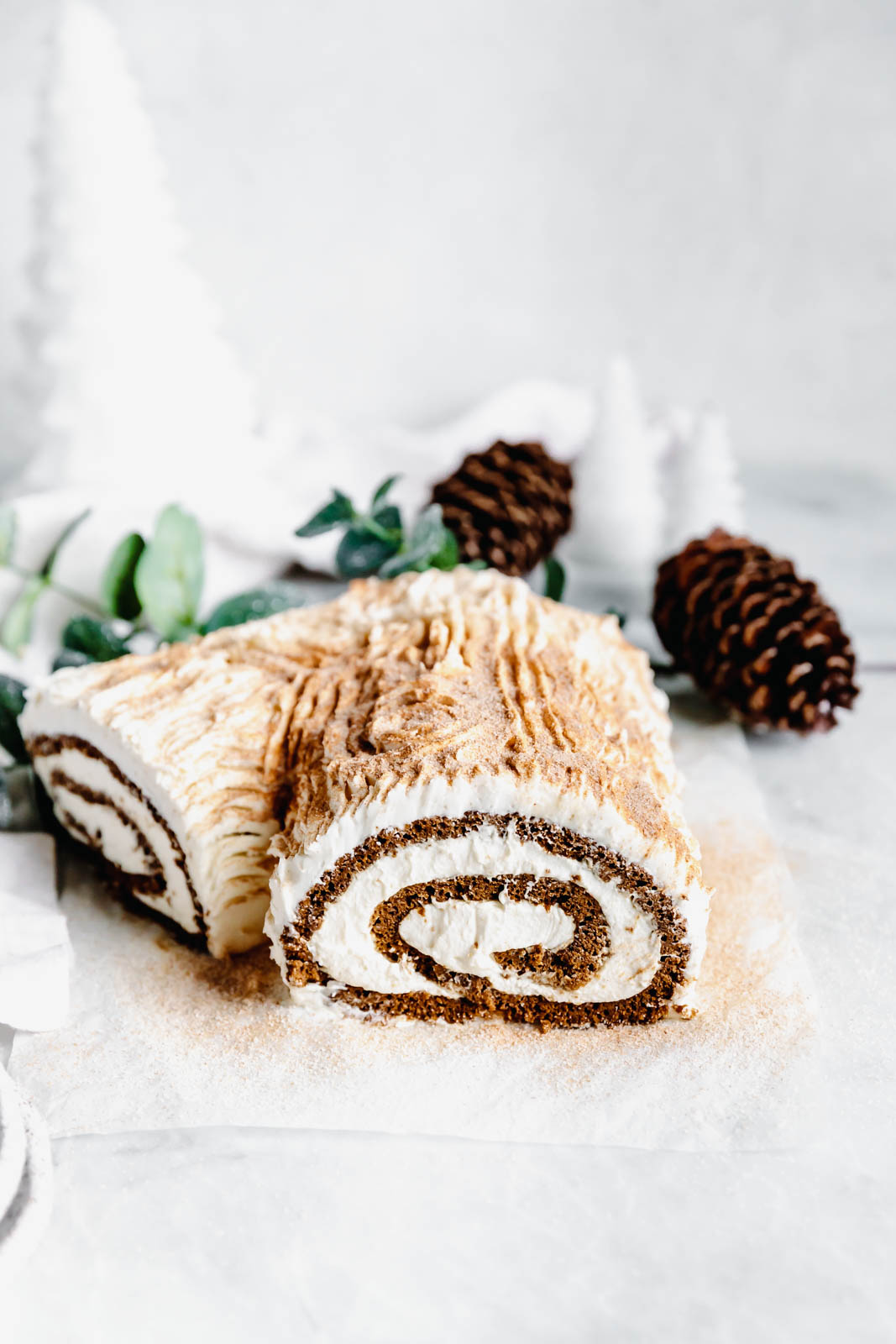This festive White Chocolate Gingerbread Yule Log is a showstopper Christmas dessert. Made with white chocolate buttercream "bark" for that rustic look!