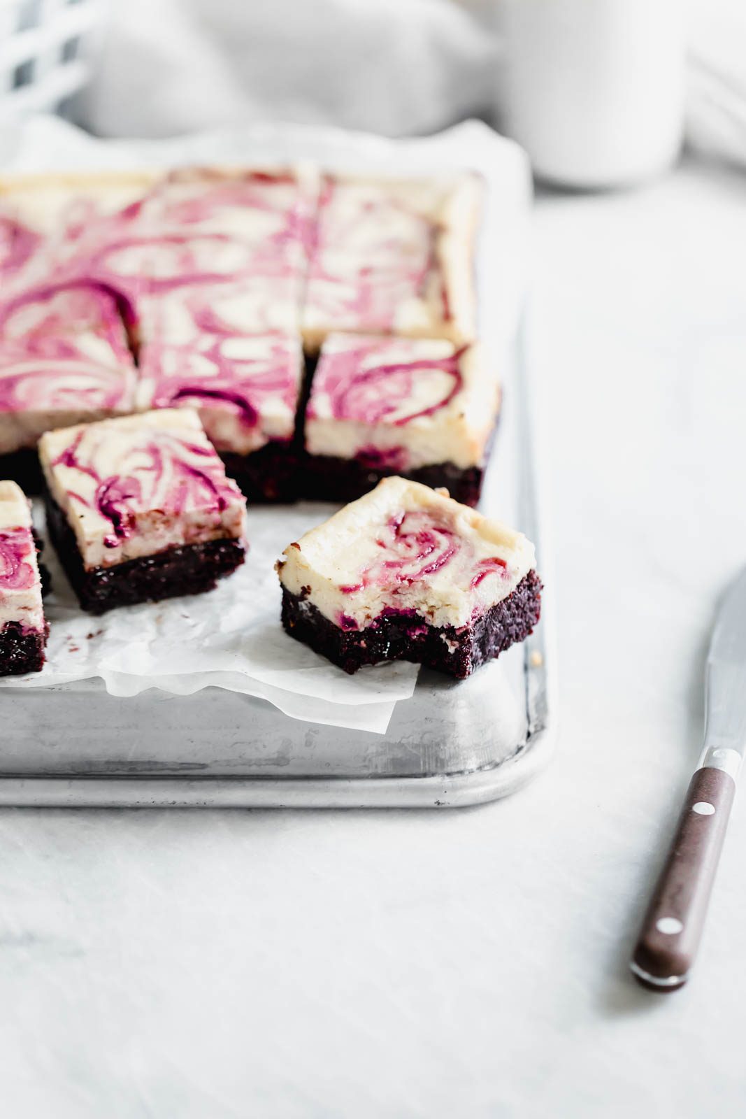 Black Cherry Cheesecake Brownies so rich and delicious you won't be able to stop at just one! Made with a black cherry swirl and fudgy brownie bottom.