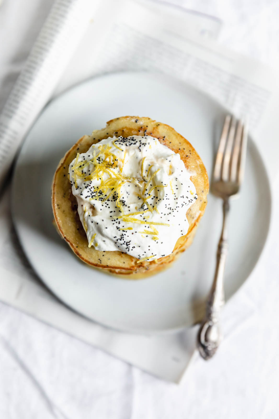 Light and fluffy Gluten Free Lemon Poppy Seed Pancakes made with almond flour and lemon zest. But proceed with caution: you might eat the whole batch!