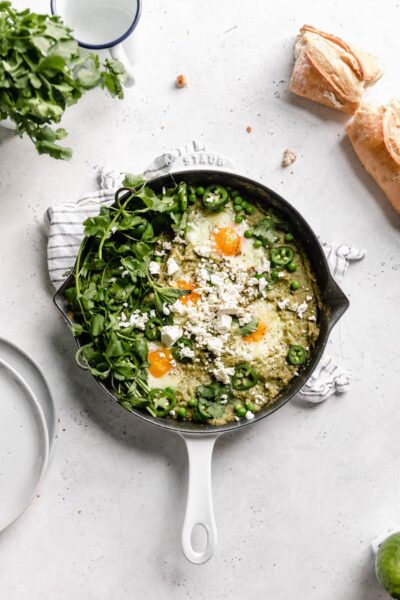 Green Shakshuka aka poached eggs cooked in a spiced green tomato sauce and topped with cilantro and feta. Talk about the best breakfast ever!