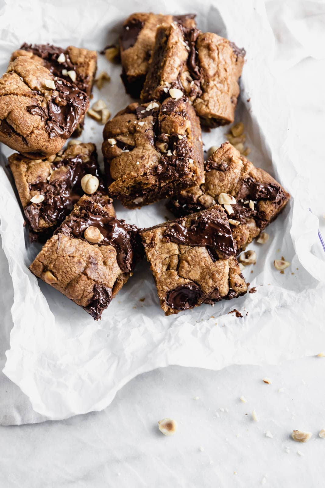 Brown Butter Nutella Chocolate Chip Cookie Bars with fat swirls of Nutella and lightly toasted hazelnuts. A salty sweet treat sure to be a showstopper.