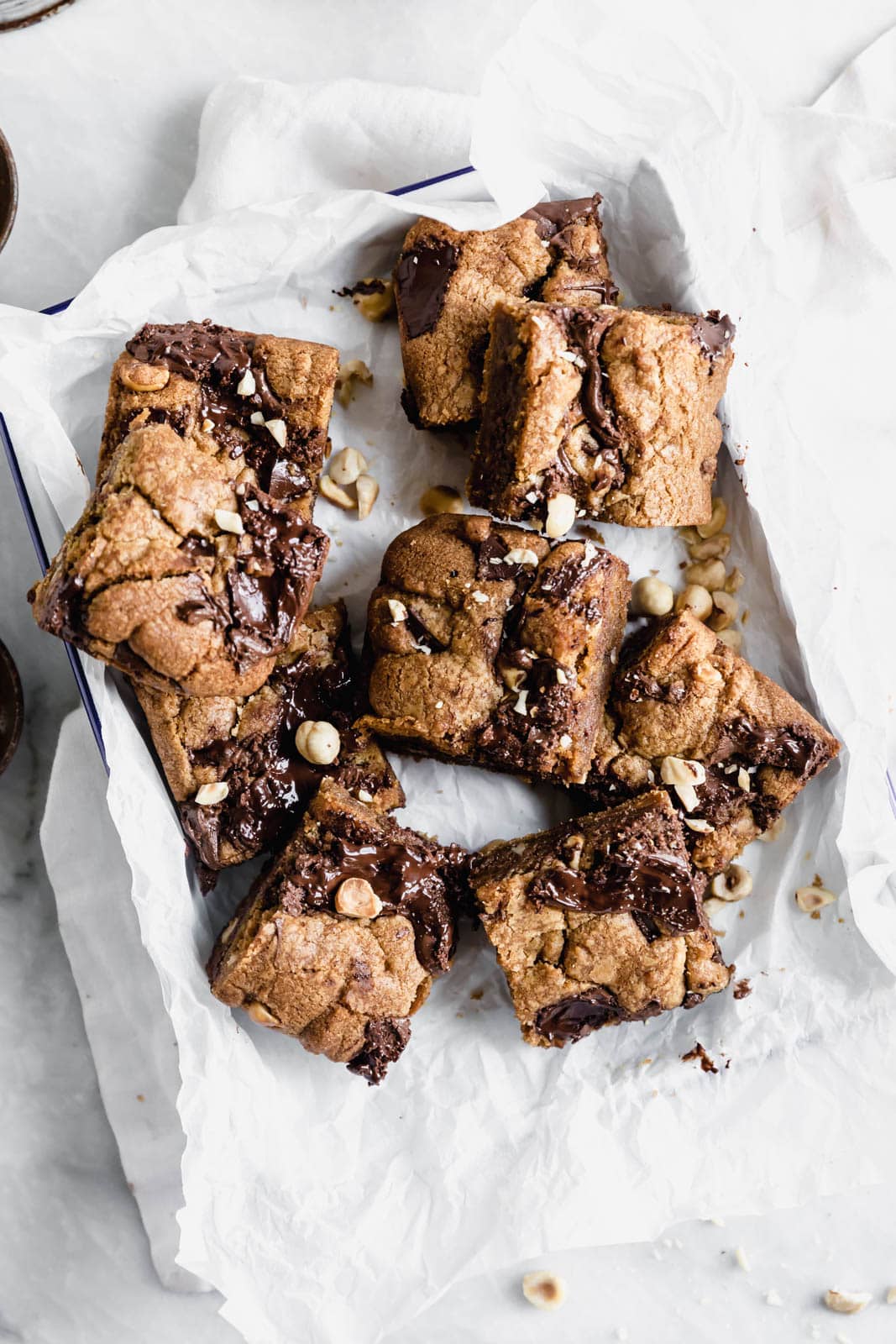 Brown Butter Nutella Chocolate Chip Cookie Bars with fat swirls of Nutella and lightly toasted hazelnuts. A salty sweet treat sure to be a showstopper.