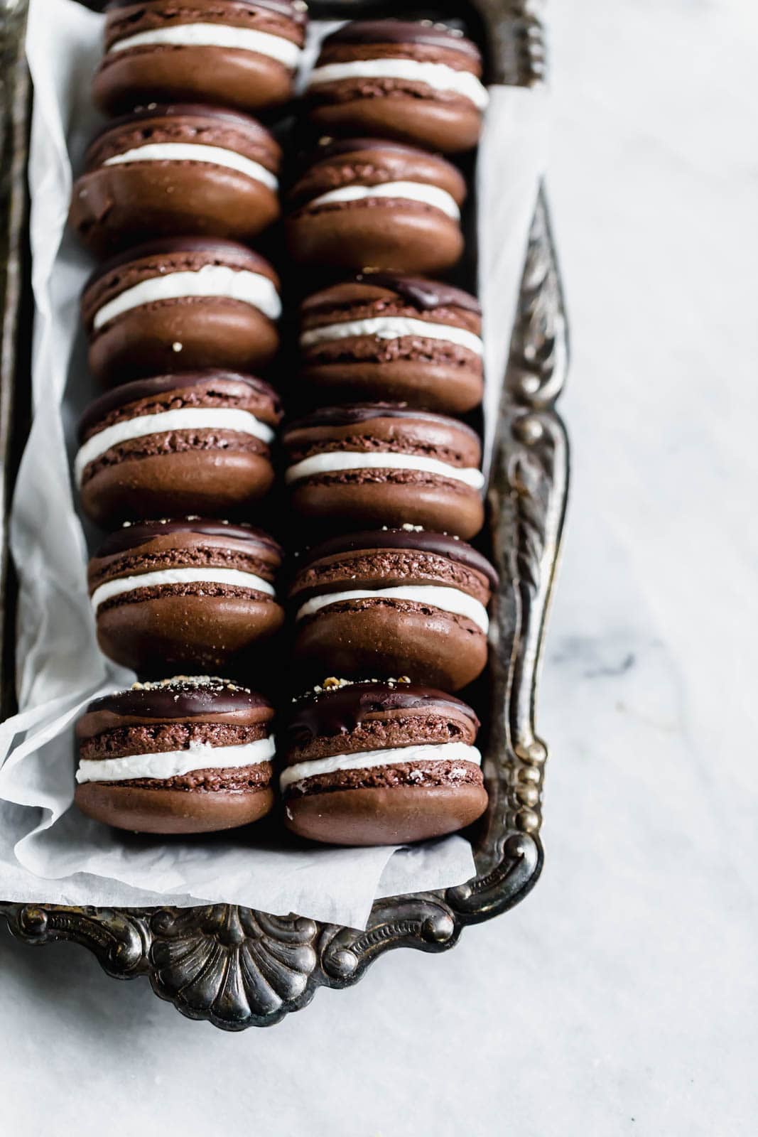 S'mores macarons with chewy chocolate macarons filled with an irresistibly fluffy marshmallow filling. All the classic campfire flavor, without the fire.