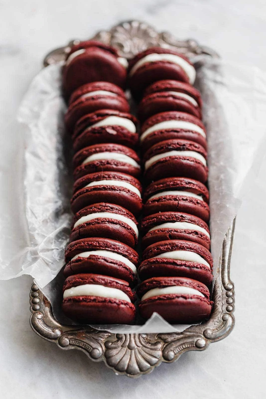 red velvet macarons in a tin