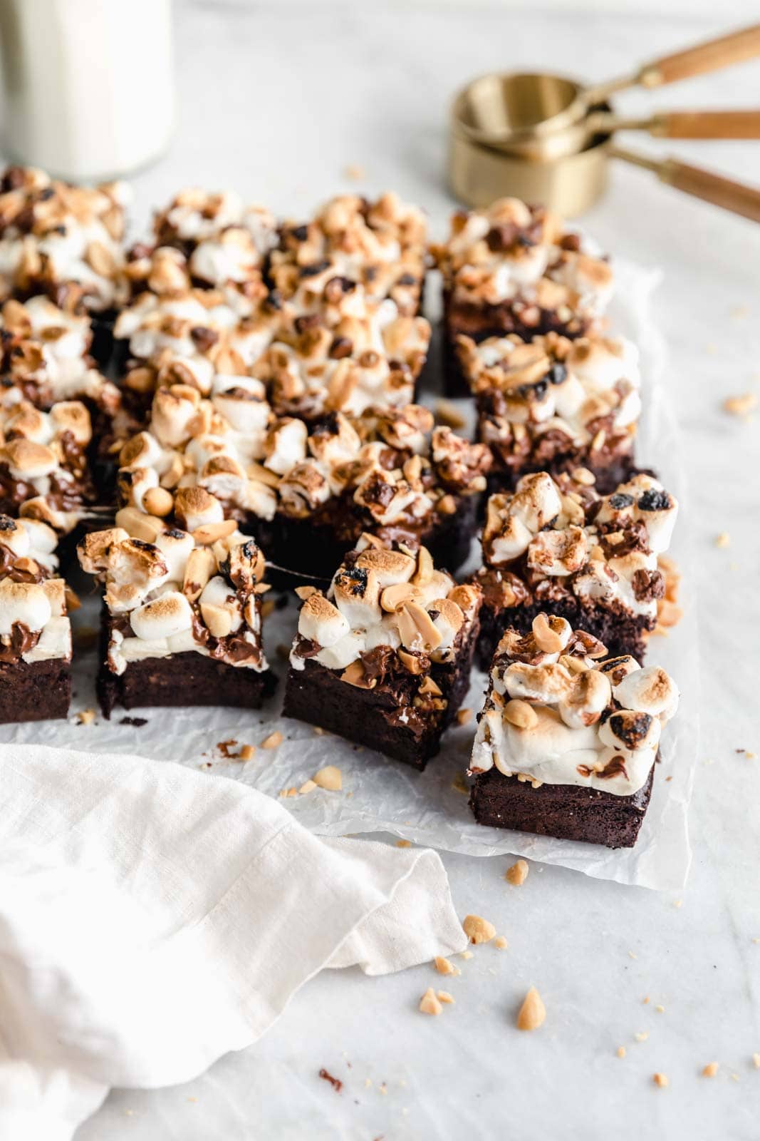 Thick fudgy brownies topped wtih marshmallows, chocolate, and peanuts