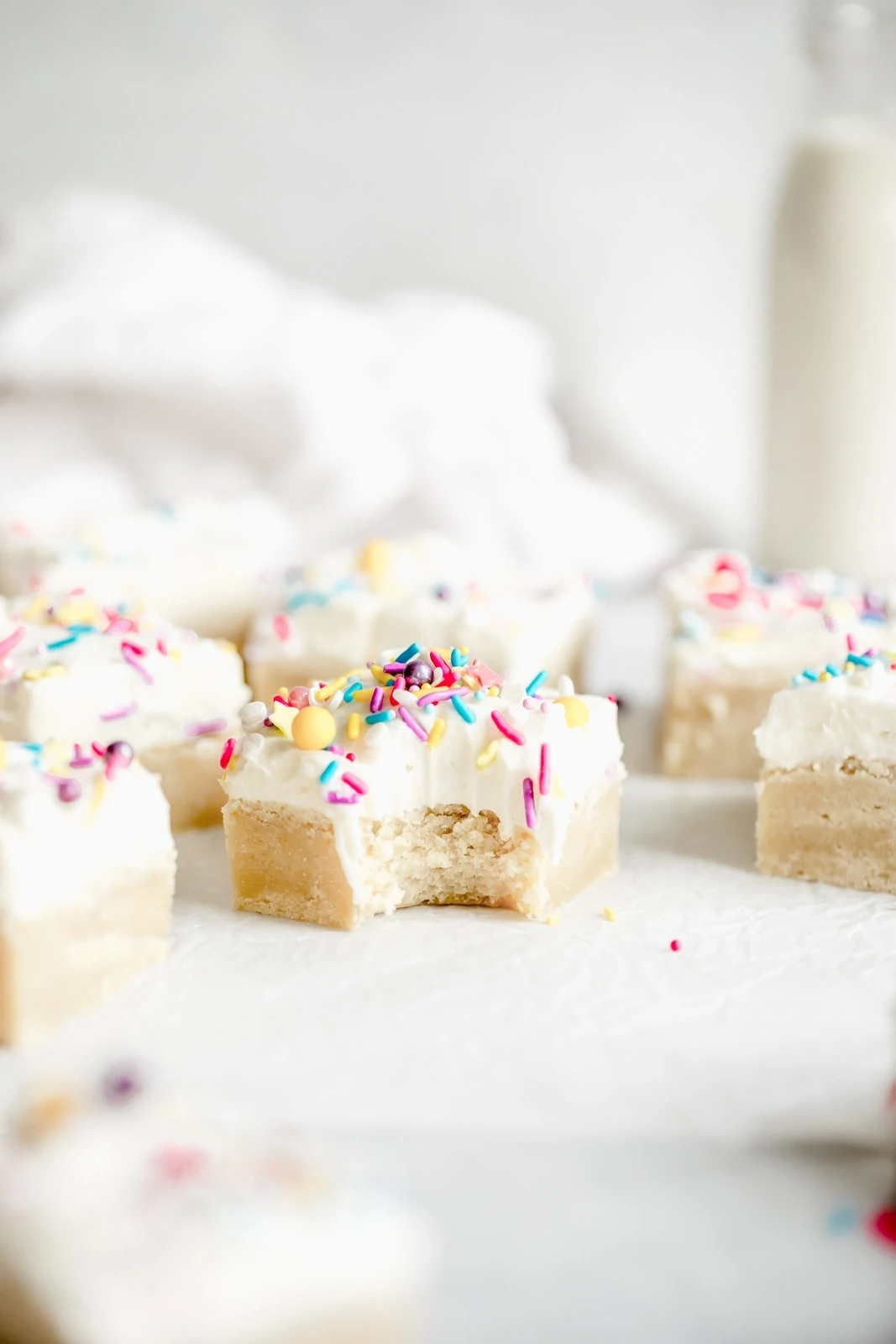 easy sugar cookie bars with frosting and sprinkles