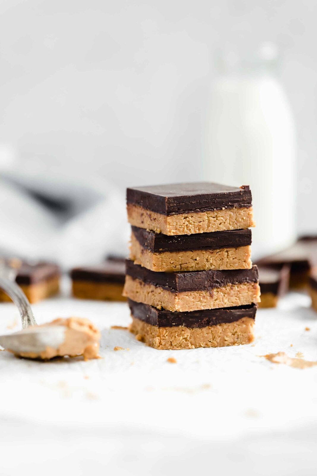 No bake healthy peanut butter chocolate bars made with just 4 ingredients! Vegan, gluten-free, and made with maple syrup, flax seed meal, & dark chocolate!