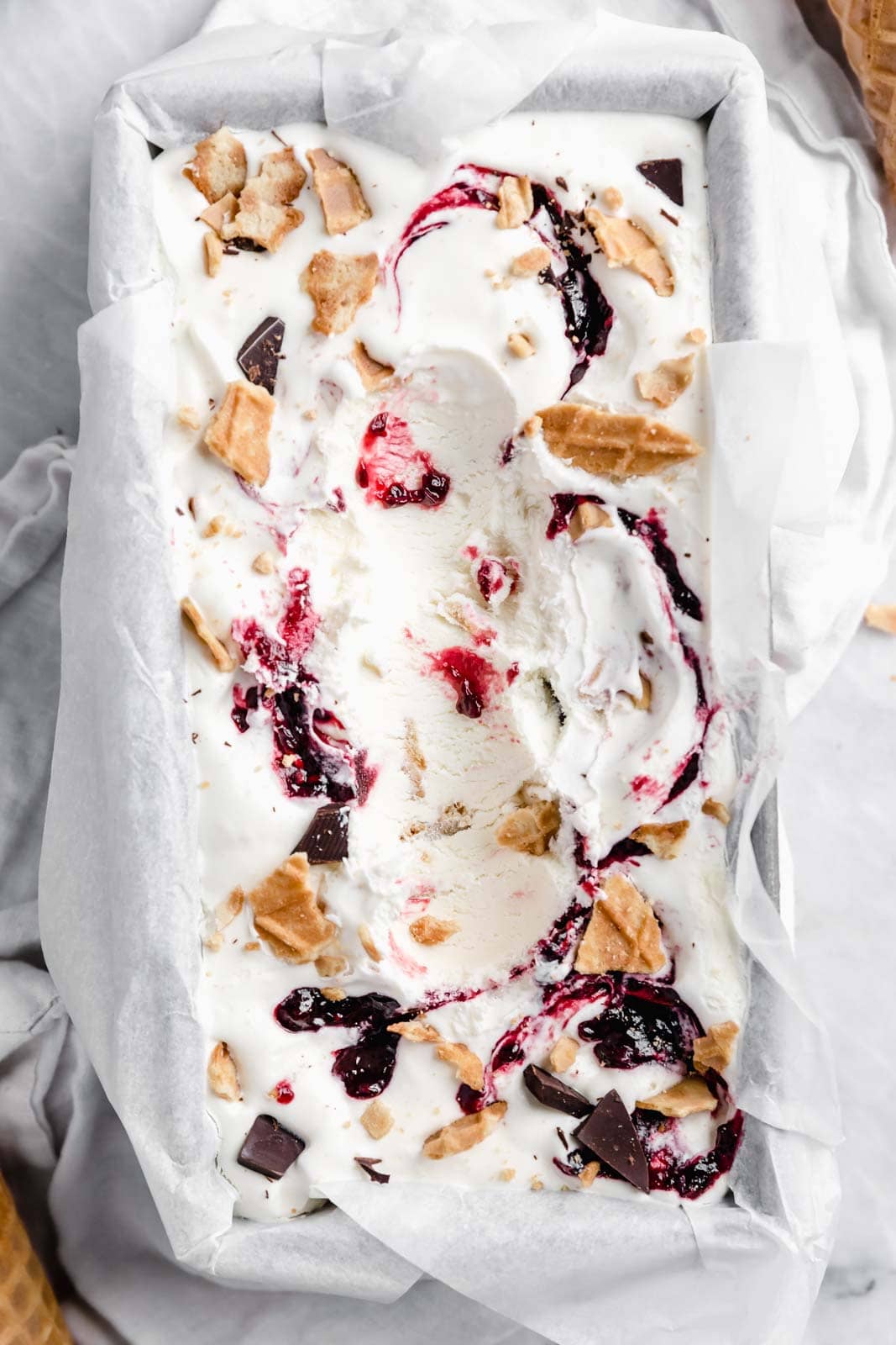 This creamy vanilla ice cream with fat blackberry swirls, buttery waffle pieces, and chocolate chips has us in heaven. Whip up this no churn blackberry waffle chocolate chip ice cream in minutes and skip the line at the ice cream shop.
