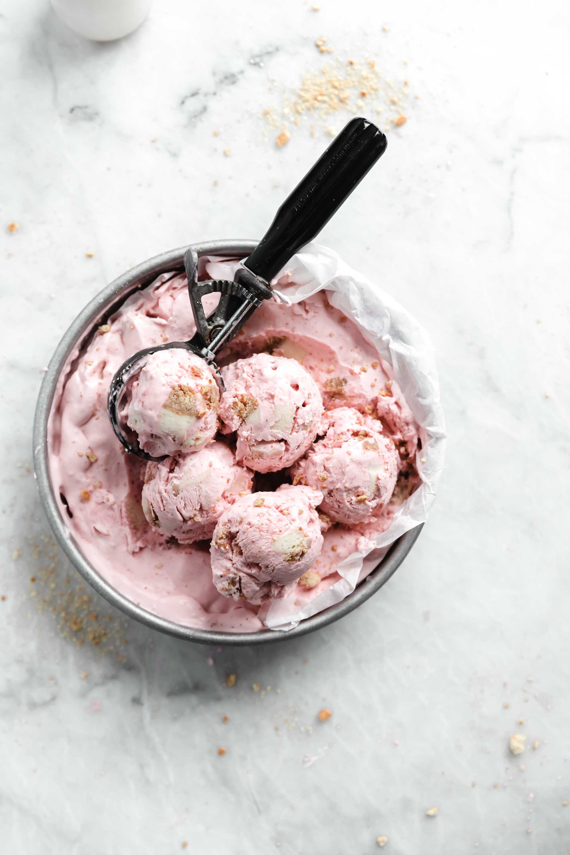 Kick off ice cream season with this easy and delicious no churn strawberry cheesecake ice cream. Creamy strawberry ice cream mixed with chunks of cheesecake. YUM.
