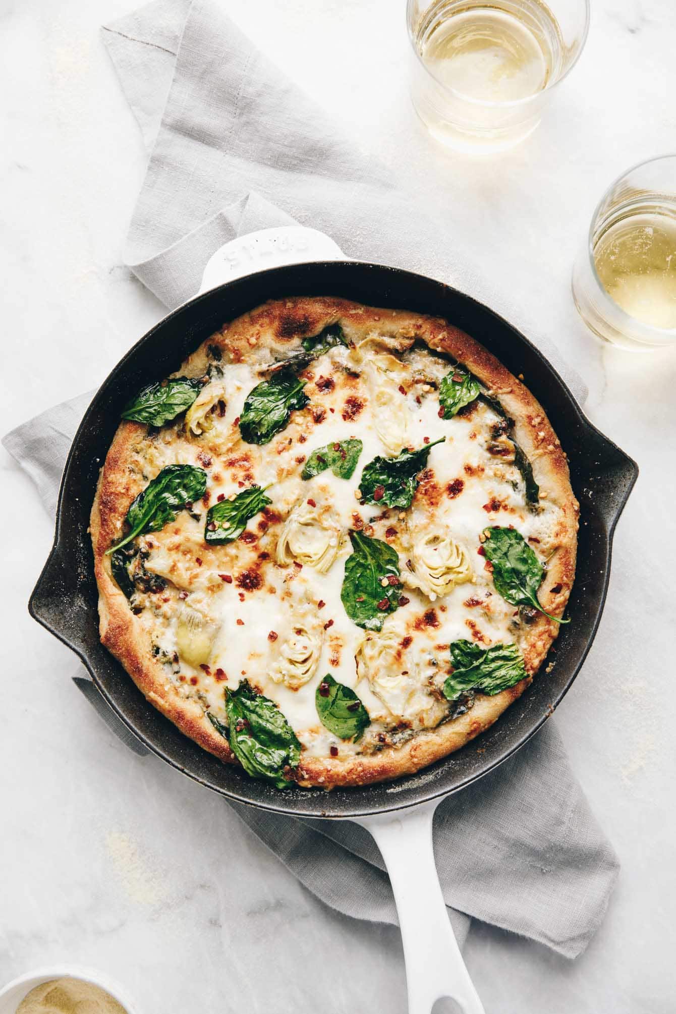 Easy cheesy spinach artichoke pizza so delicious, you'll eat the whole pie yourself