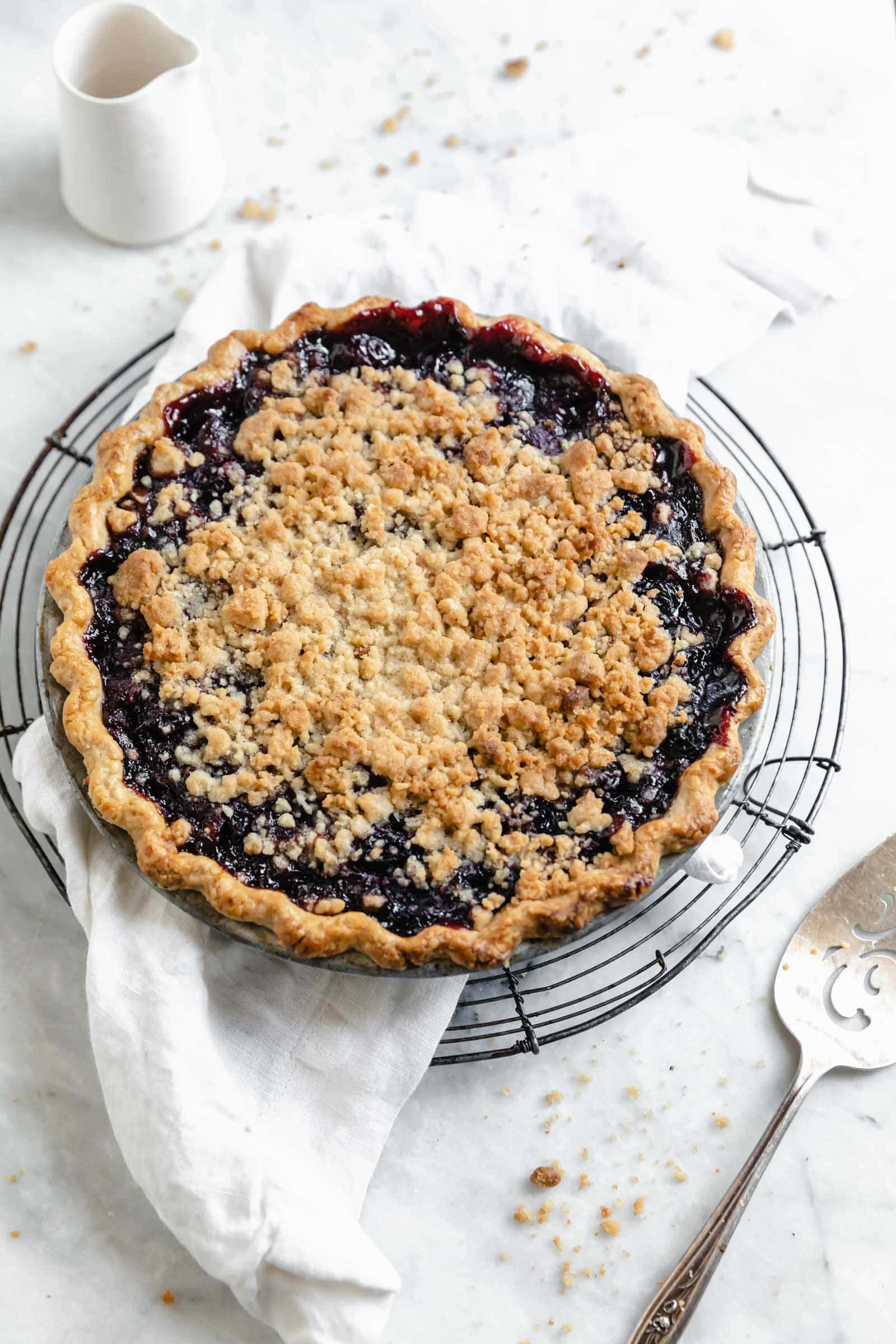 Introducing our favorite summer pie: Cherry Crumb Pie. A flaky pie crust filled with fresh cherries, and topped with crumble. The perfect cherry pie recipe!