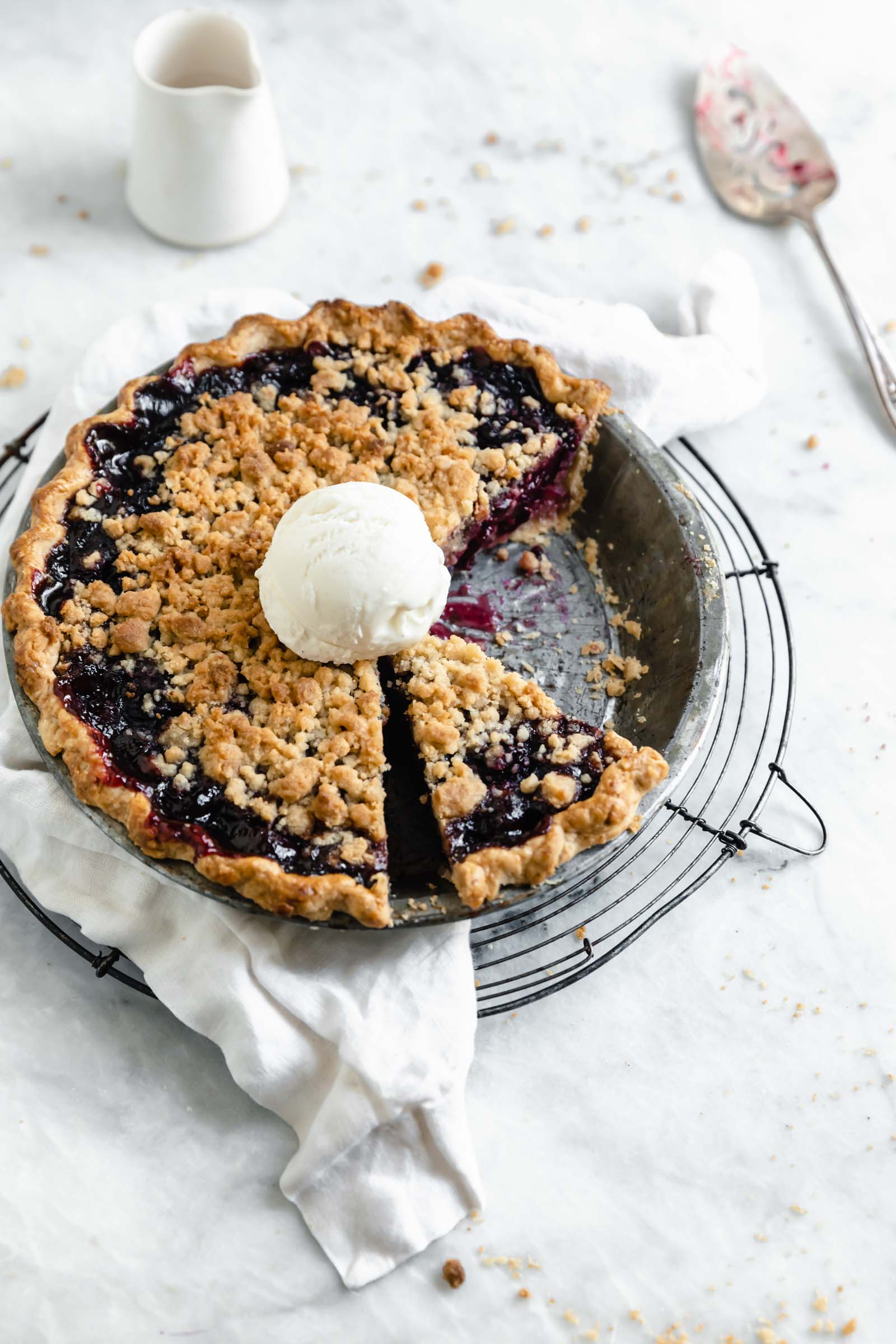 cherry pie with crumble topping and a scoop of ice cream