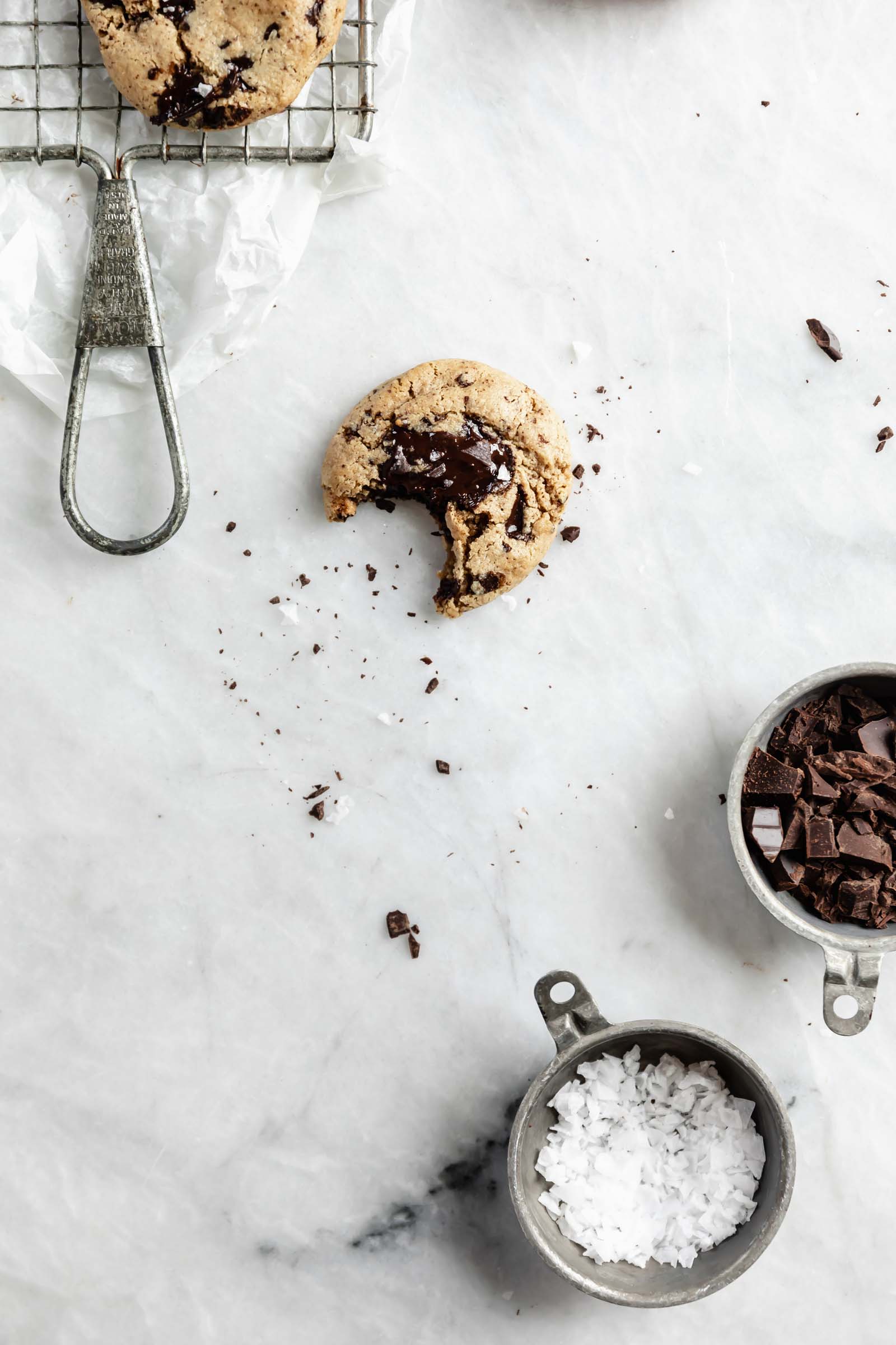 gluten free chocolate chip cookies with crumbs, salt, and chocolate