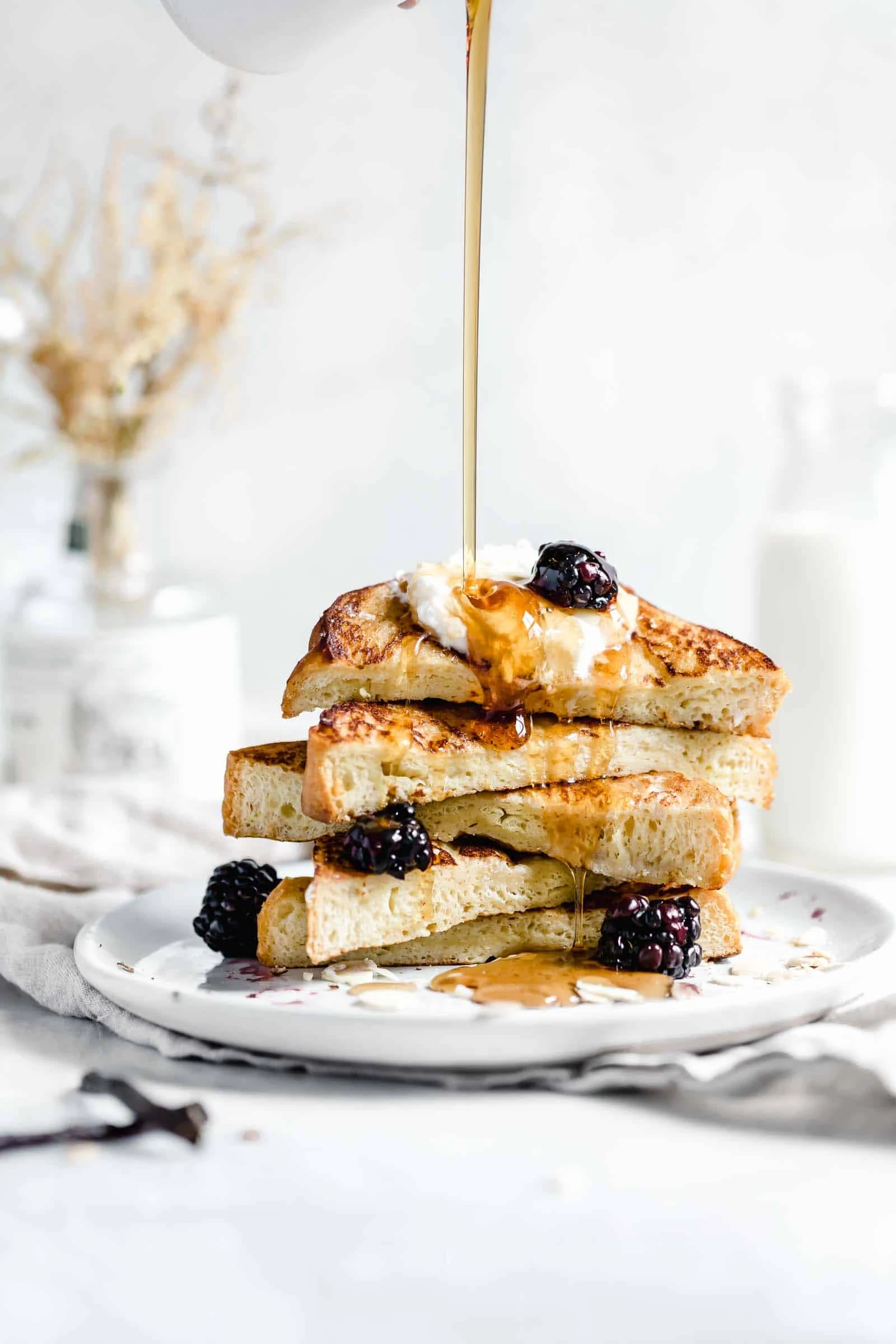 bourbon vanilla french toast drizzled with maple syrup pour