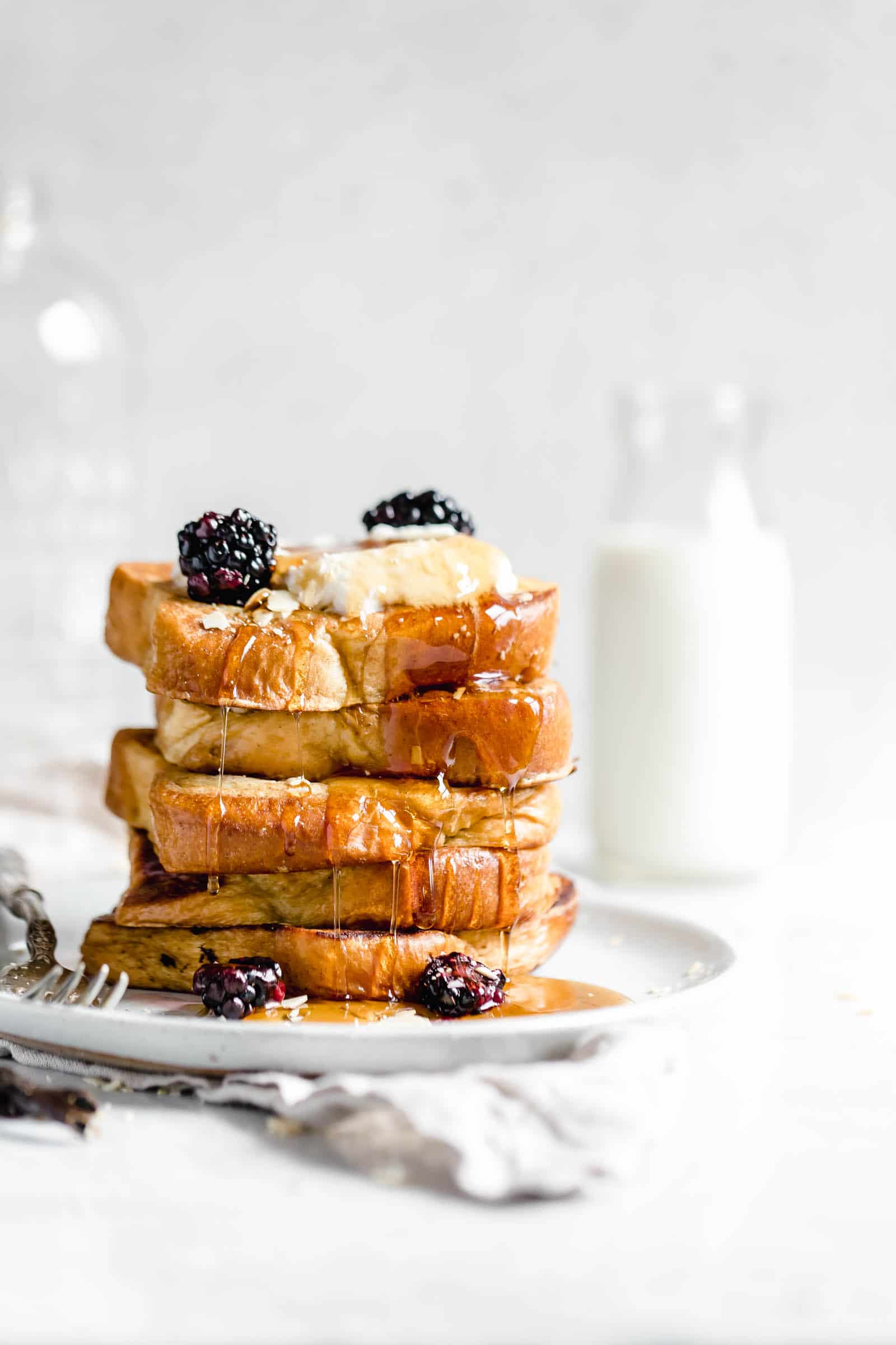 stack of bourbon vanilla french toast with glass of milk