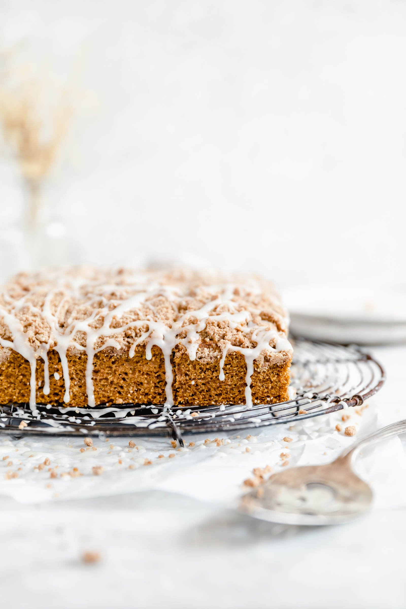 pumpkin coffee cake with crumble topping and cinnamon cream cheese glaze