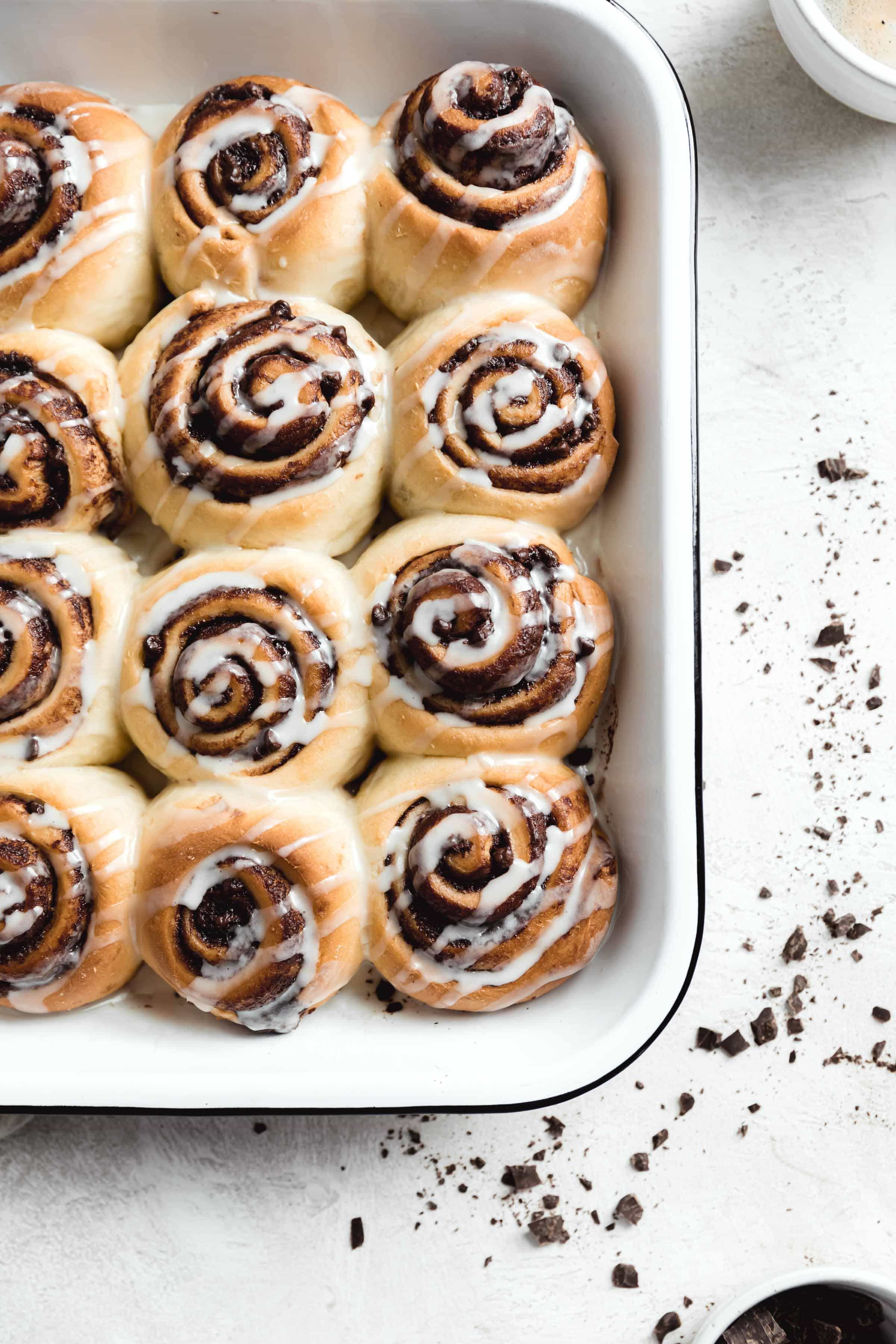 Nothing says holiday baking more than cinnamon rolls...except maybe CHOCOLATE cinnamon rolls. These pillow soft cinnamon rolls are filled with chocolate, drizzled wit the most perfect cream cheese icing and absolutely scrumptious. Best part? They’re ready in under an hour. #cinnamonrolls #bromabakery #foodphotography #easy