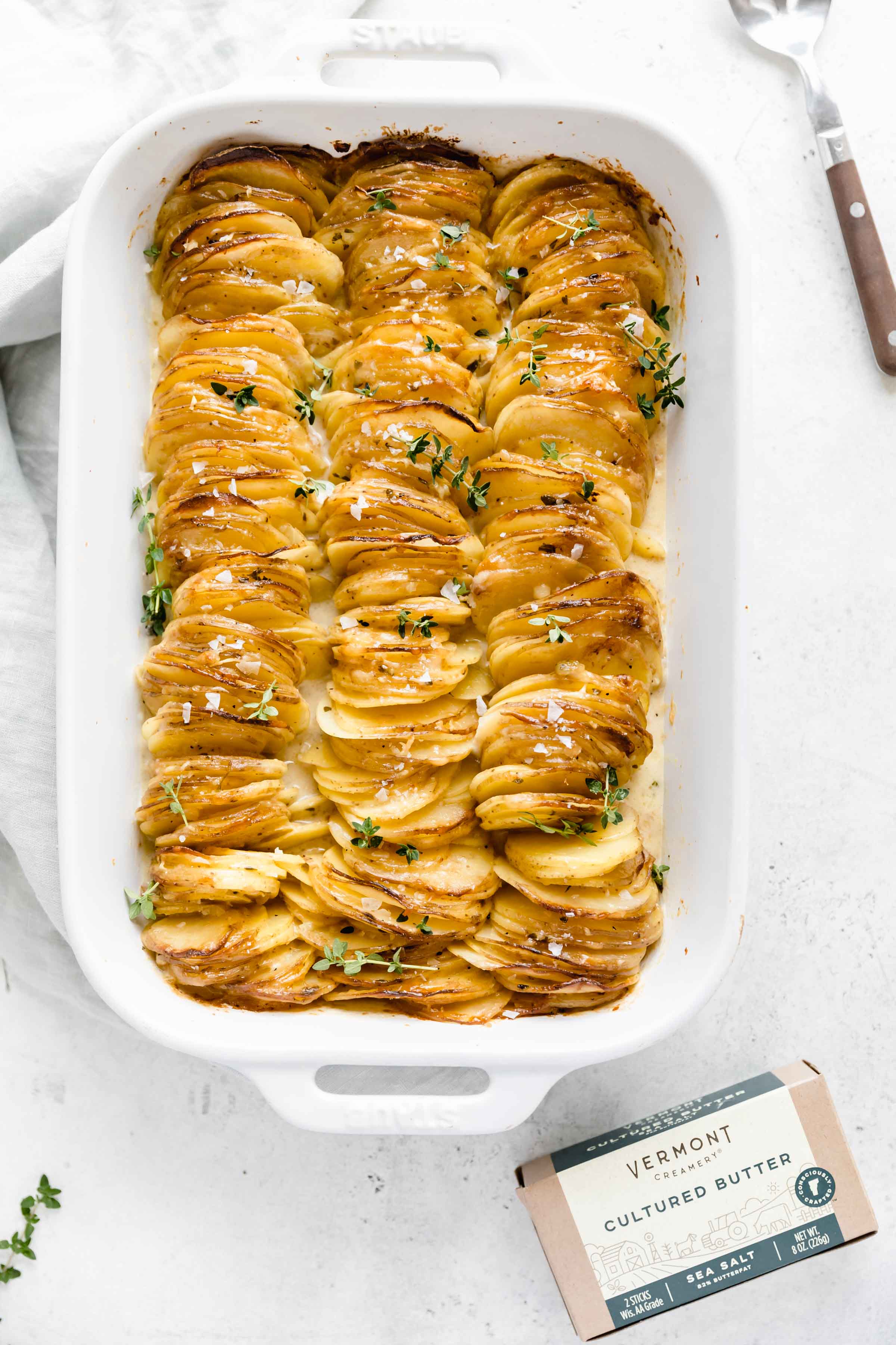 Cheesy Scalloped Potatoes stacked vertically to create a crispy, gooey, cheesy side dish the whole family will love!
