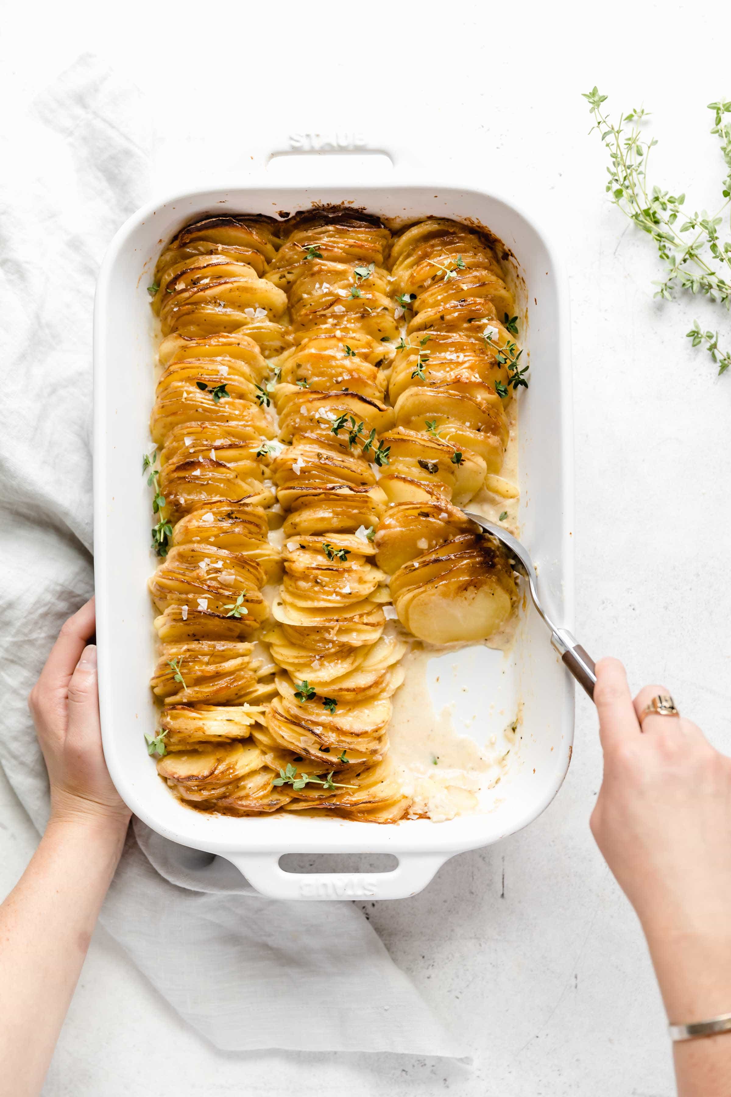 overhead shot of the dreamiest cheesiest creamy hasselback style cheesy scalloped potatoes