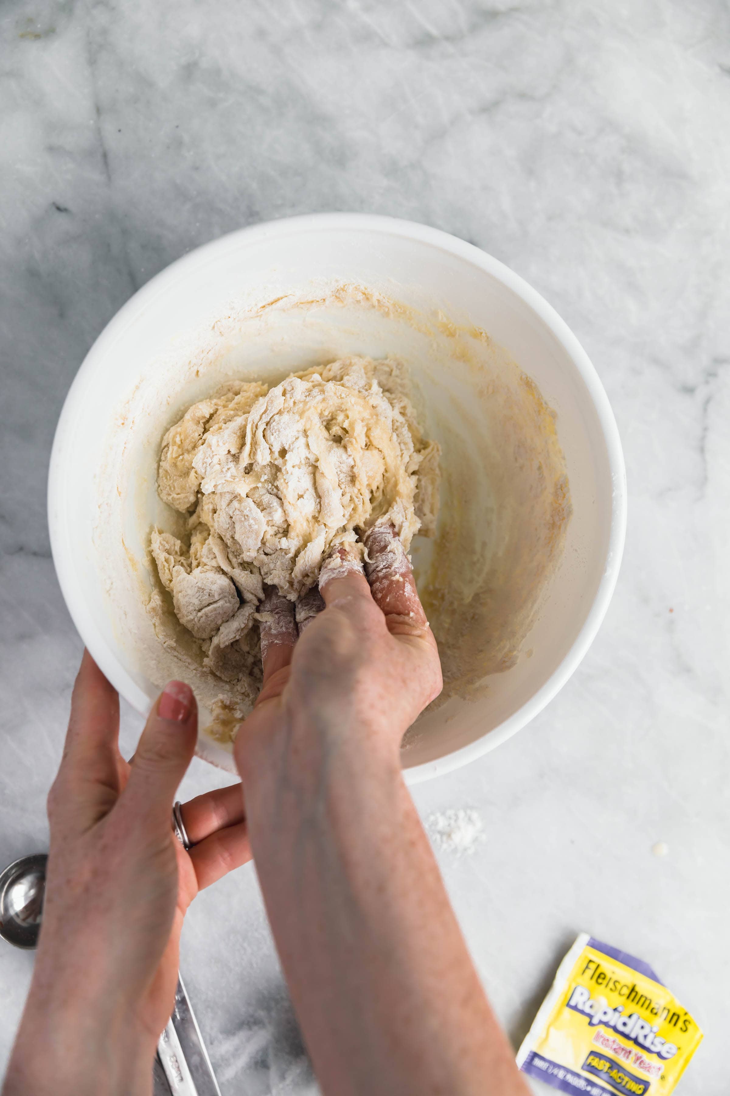 stir together cinnamon roll dough with hands