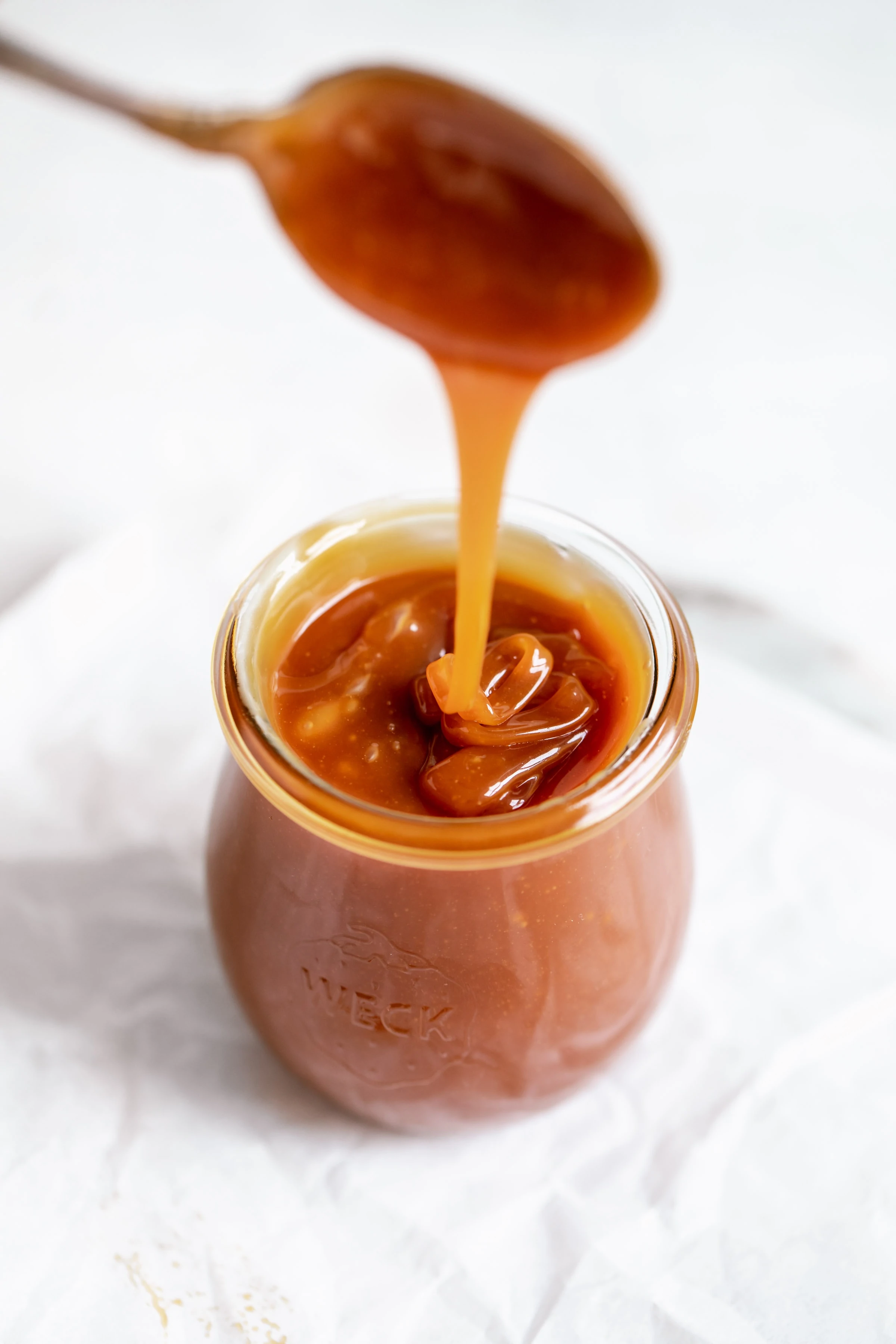 easy homemade caramel in a glass jar with a drip