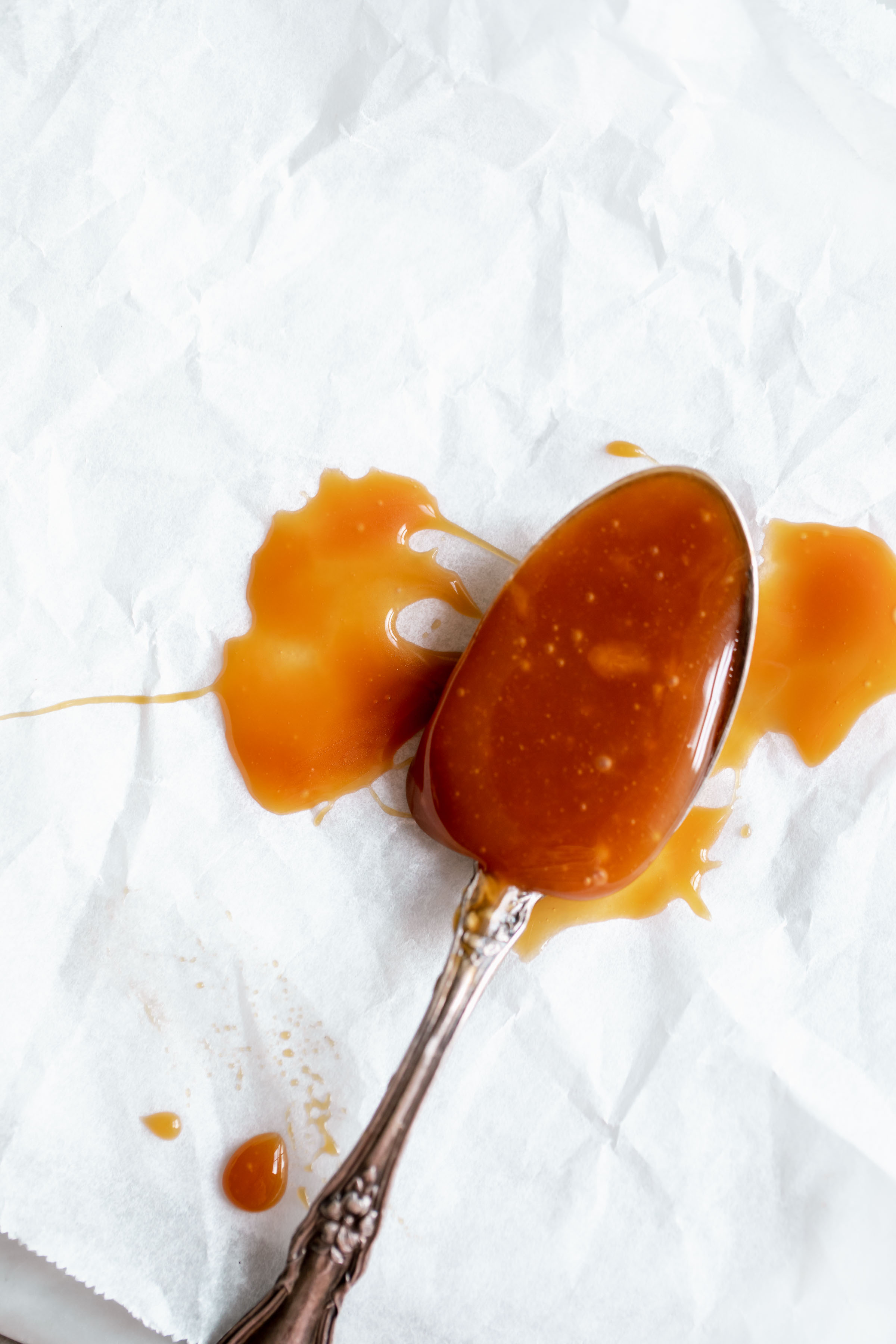 spoonful of easy homemade caramel on parchment paper