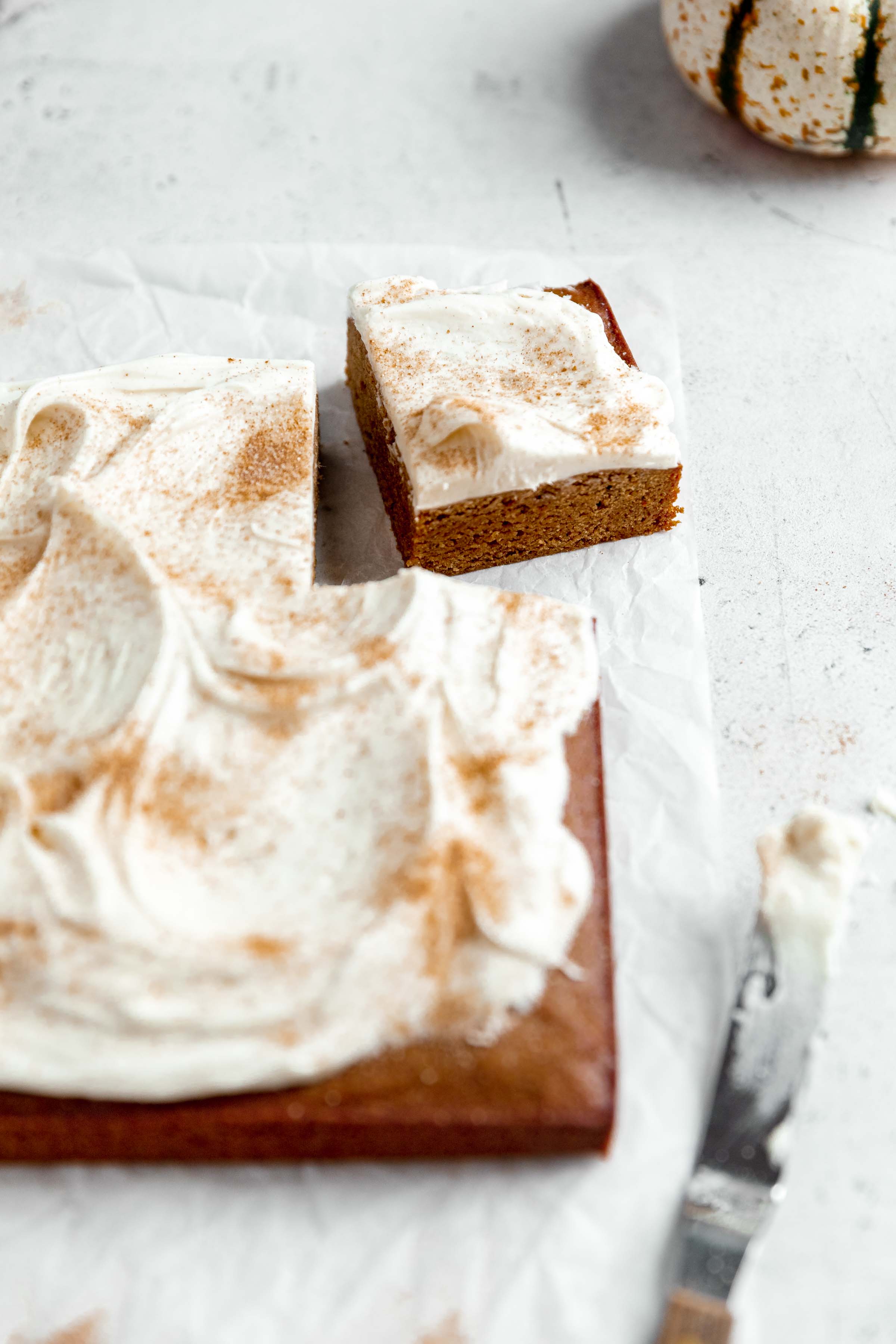 gingerbread blondies with a cinnamon cream cheese glaze with one piece cut out